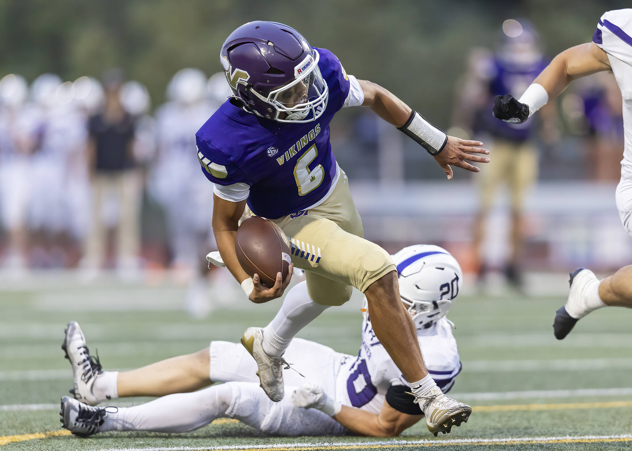Lake Stevens’ Blake Moser escapes a tackle as he runs into the end zone for a touchdown during the game against Sumner on Friday, Sept. 5, 2025 in Lake Stevens, Washington. (Olivia Vanni / The Herald)