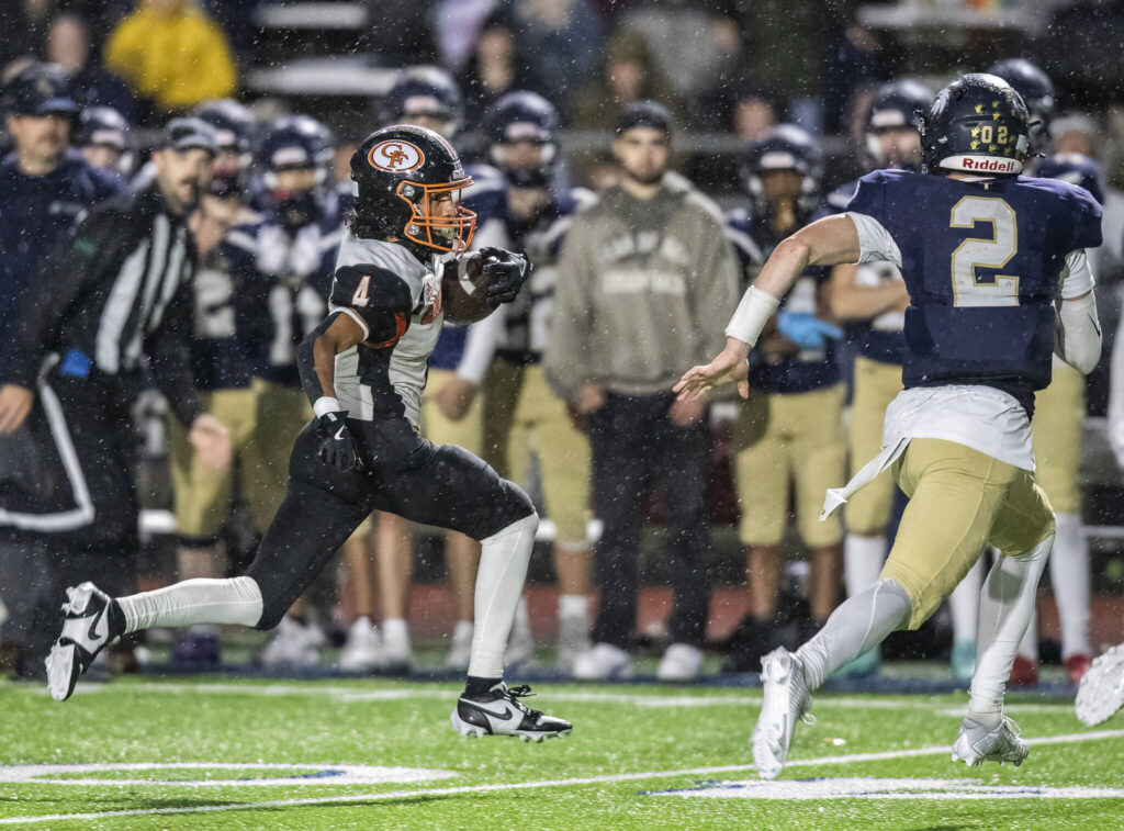 Granite Falls’ Dwayne Pocknett runs the ball up field after picking off a pass by Cedar Park Christian’s Tre Samuelu during the game on Oct. 24, 2025 in Kirkland, Washington. (Olivia Vanni / The Herald)
