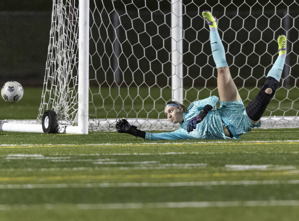 Stanwood’s Bella Braley lays out to block a shot during the game against Snohomish on Oct. 27, 2025 in Snohomish, Washington. (Olivia Vanni / The Herald)