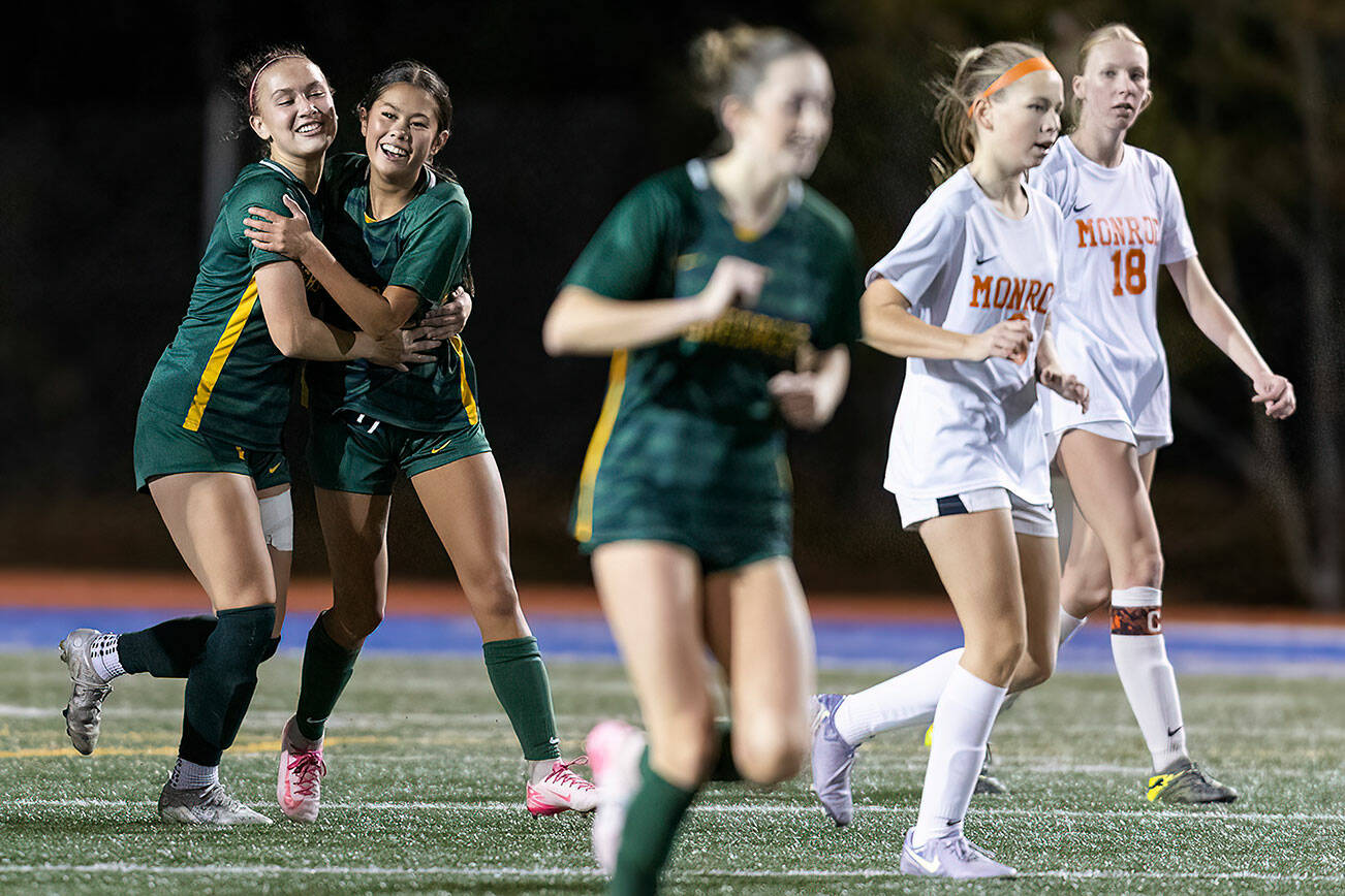 Shorecrest’s Olivia Taylor hugs Shorecrest’s Nemesia Peters after scoring a goal against Monroe during the 3A girls district game on Nov. 4, 2025 in Shoreline, Washington. (Olivia Vanni / The Herald)