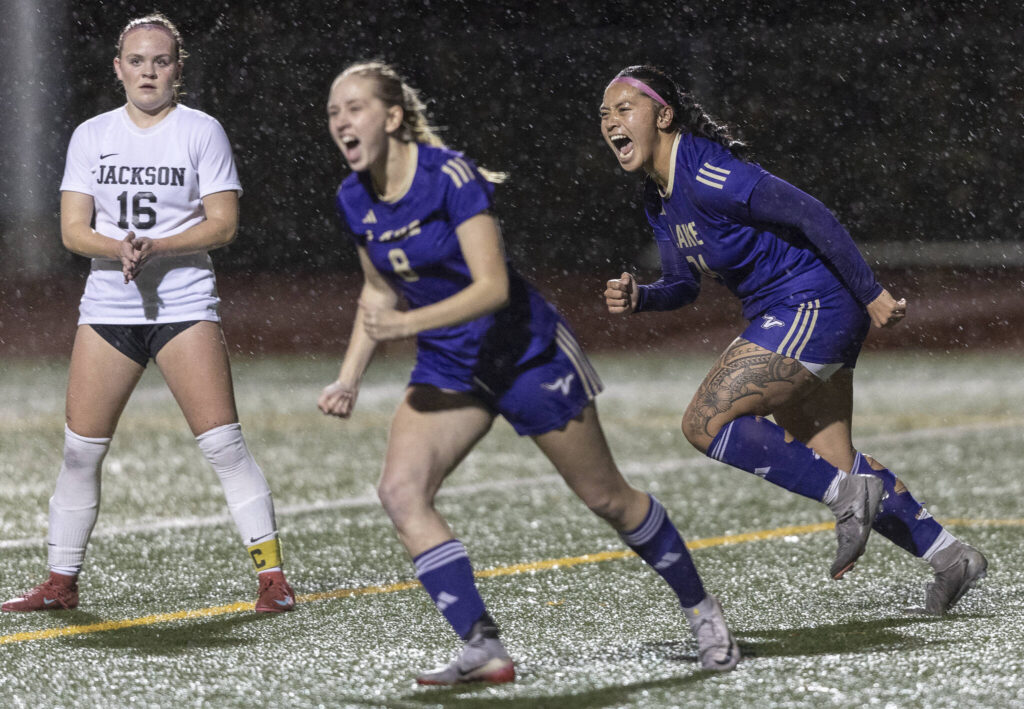 Lake Stevens’ Keira Isabelle Tupua and Carley Robertson yell in celebration after Lake Stevens’ Noelani Tupua scores during the 4A girls district game against Jackson on Nov. 5, 2025 in Lake Stevens, Washington. (Olivia Vanni / The Herald)
