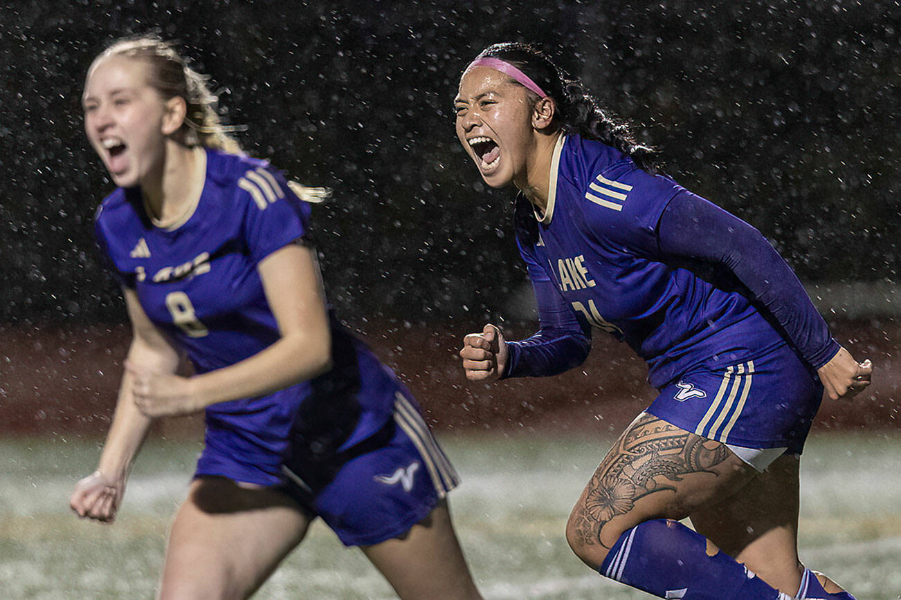 Lake Stevens’ Keira Isabelle Tupua and Carley Robertson yell in celebration after Lake Stevens’ Noelani Tupua scores during the 4A girls district game against Jackson on Nov. 5, 2025 in Lake Stevens, Washington. (Olivia Vanni / The Herald)
