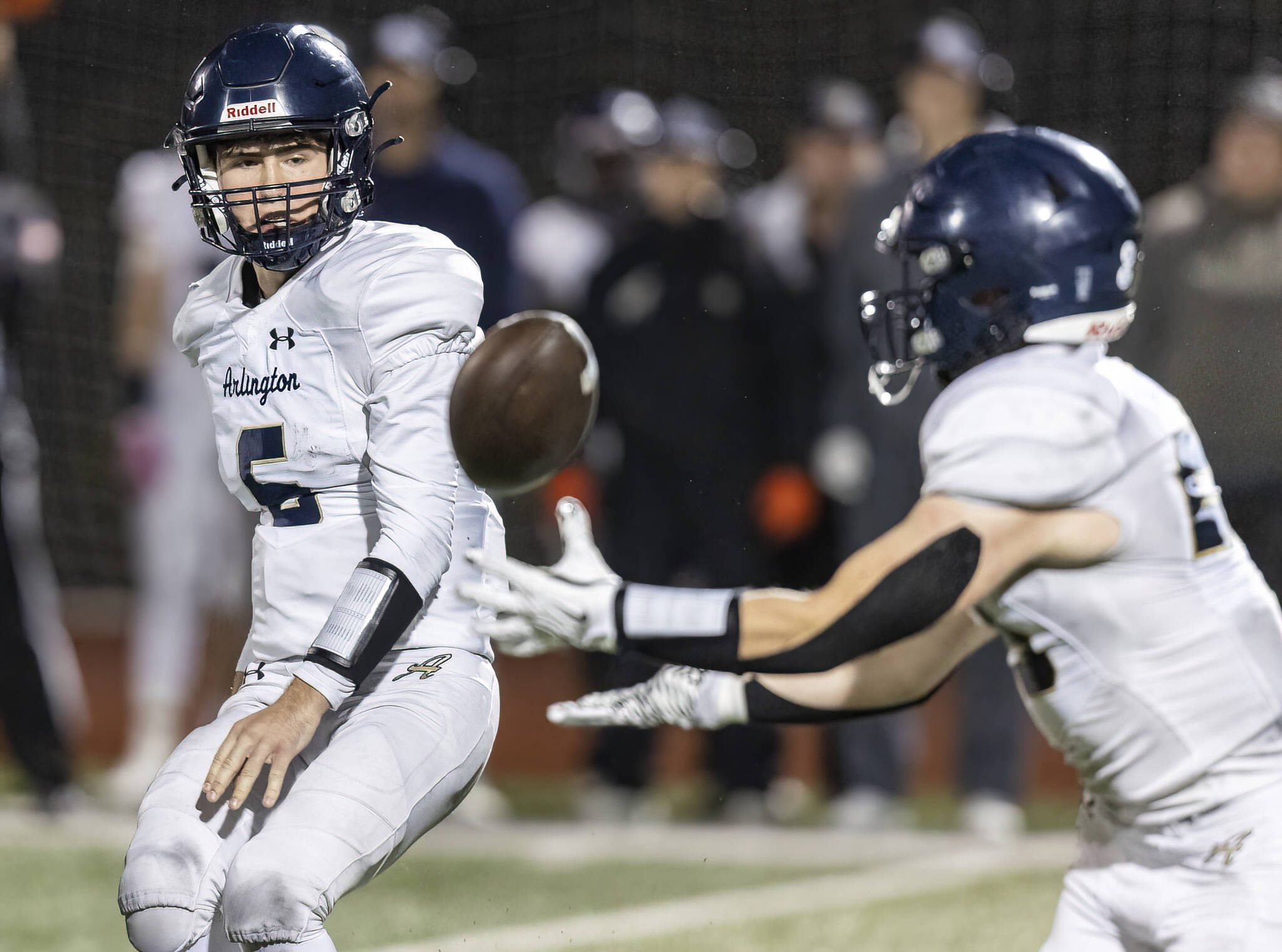 Arlington’s Kaleb Bartlett-Wood tosses the ball during the game against Lake Stevens on Oct. 31, 2025 in Lake Stevens, Washington. (Olivia Vanni / The Herald)