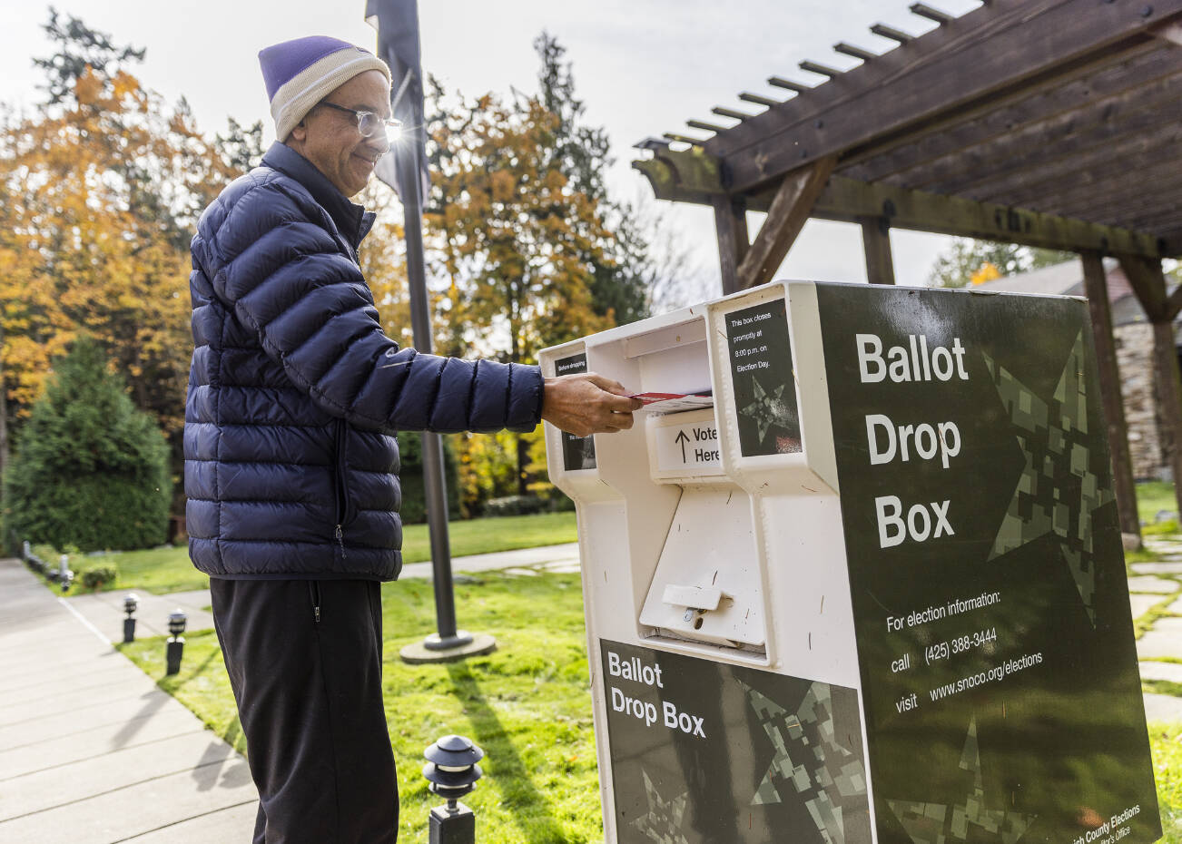Eric Rasmussen drops his ballot in the ballot box outside of Town of Woodway Town Hall on Nov. 4, 2025 in Edmonds, Washington. (Olivia Vanni / The Herald)