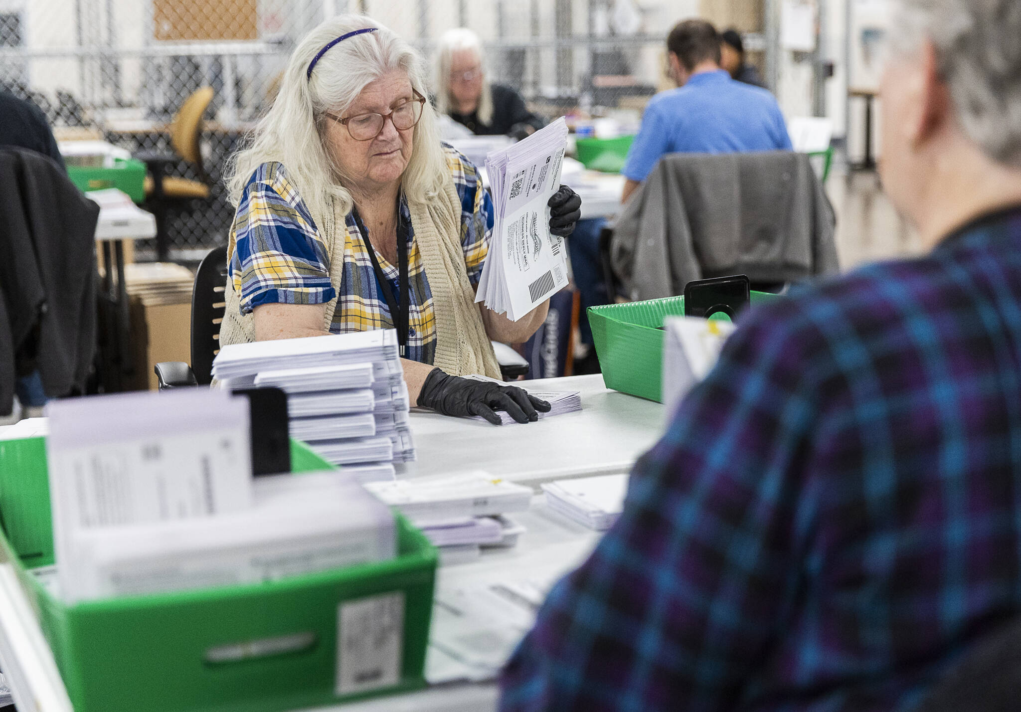 Jenita Vogt opens ballots with acceptable signatures to be scanned in the Snohomish County Election Center on Nov. 3, 2025 in Everett, Washington. (Olivia Vanni / The Herald)