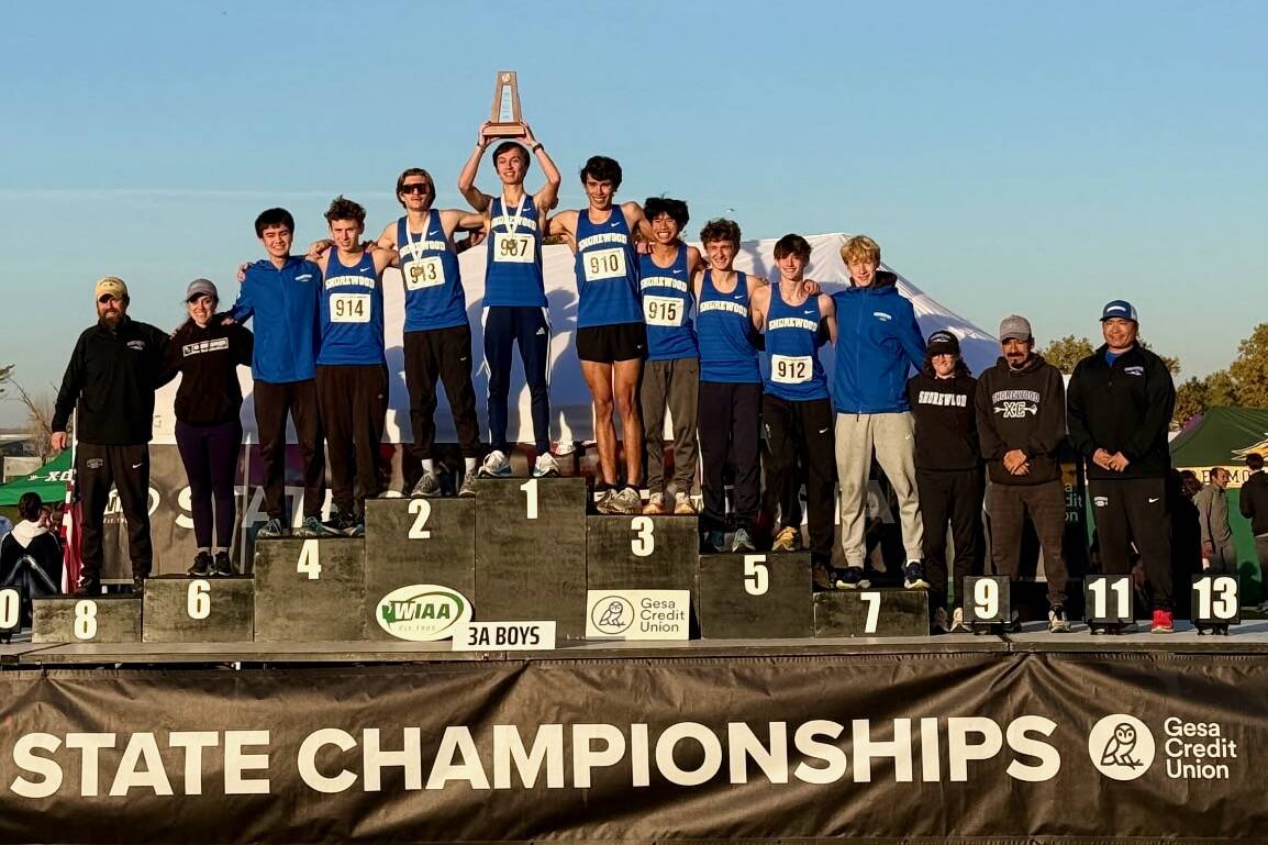 The Shorewood boys cross country team poses with its trophy on the podium after placing second in the 3A State Championship at Sun Willows Golf Course in Pasco on Nov. 8, 2025. (Photo courtesy Joel Reese)