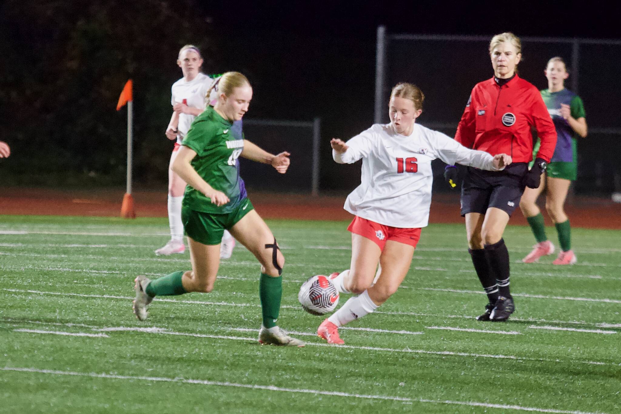 Edmonds-Woodway junior Audrey Rothmier (left) fights for a 50/50 ball against Silas sophomore Allison Conn during the Warriors 1-0 overtime loss to the Rams in the 3A Girls State Soccer Play-in Round at Edmonds Stadium on Nov. 12, 2025. (Joe Pohoryles / The Herald)