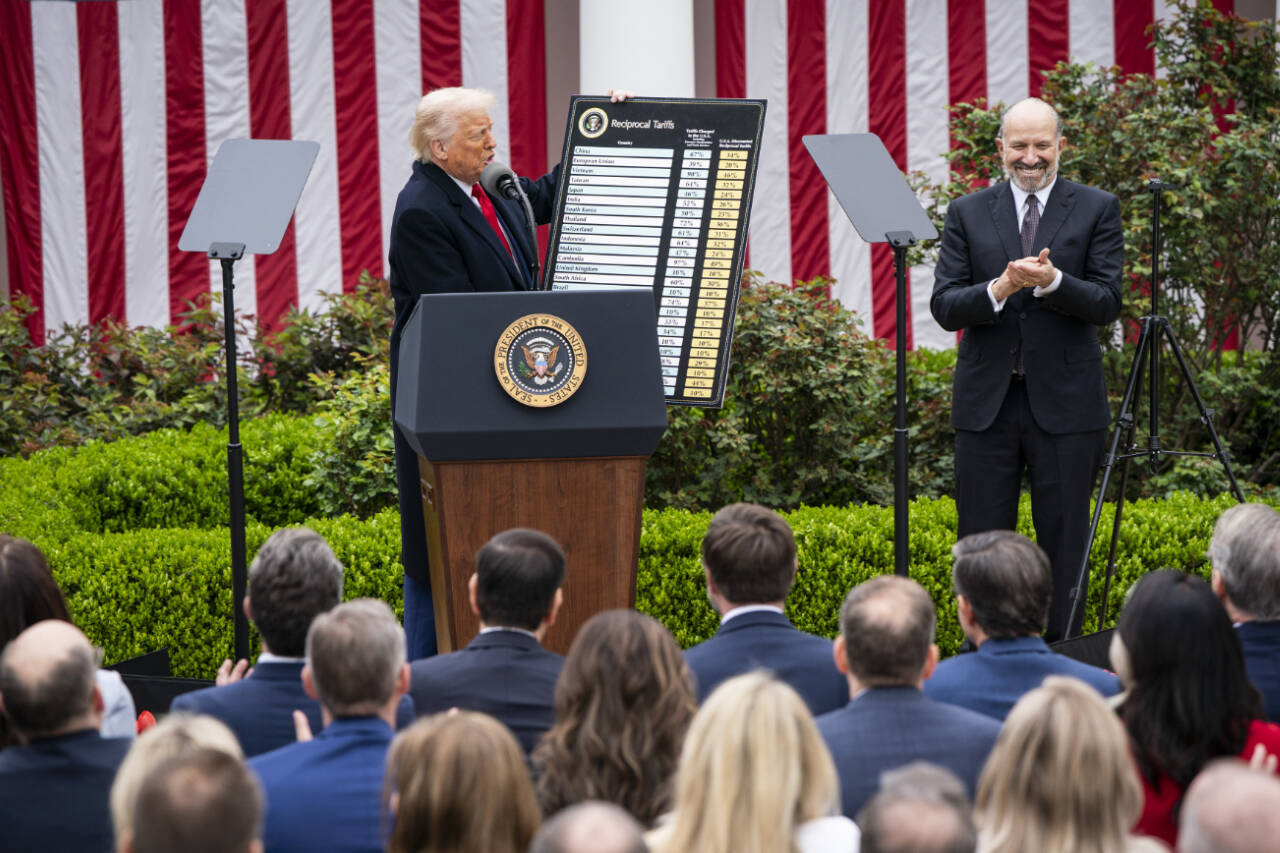 President Donald Trump and Secretary of Commerce Howard Lutnick display a chart detailing tariffs, at the White House in Washington, D.C., on April 2. Supreme Court Justices heard arguments on Nov. 5, over whether the president acted legally when he used a 1977 emergency statute to unilaterally impose tariffs. (Haiyun Jiang / The New York Times)