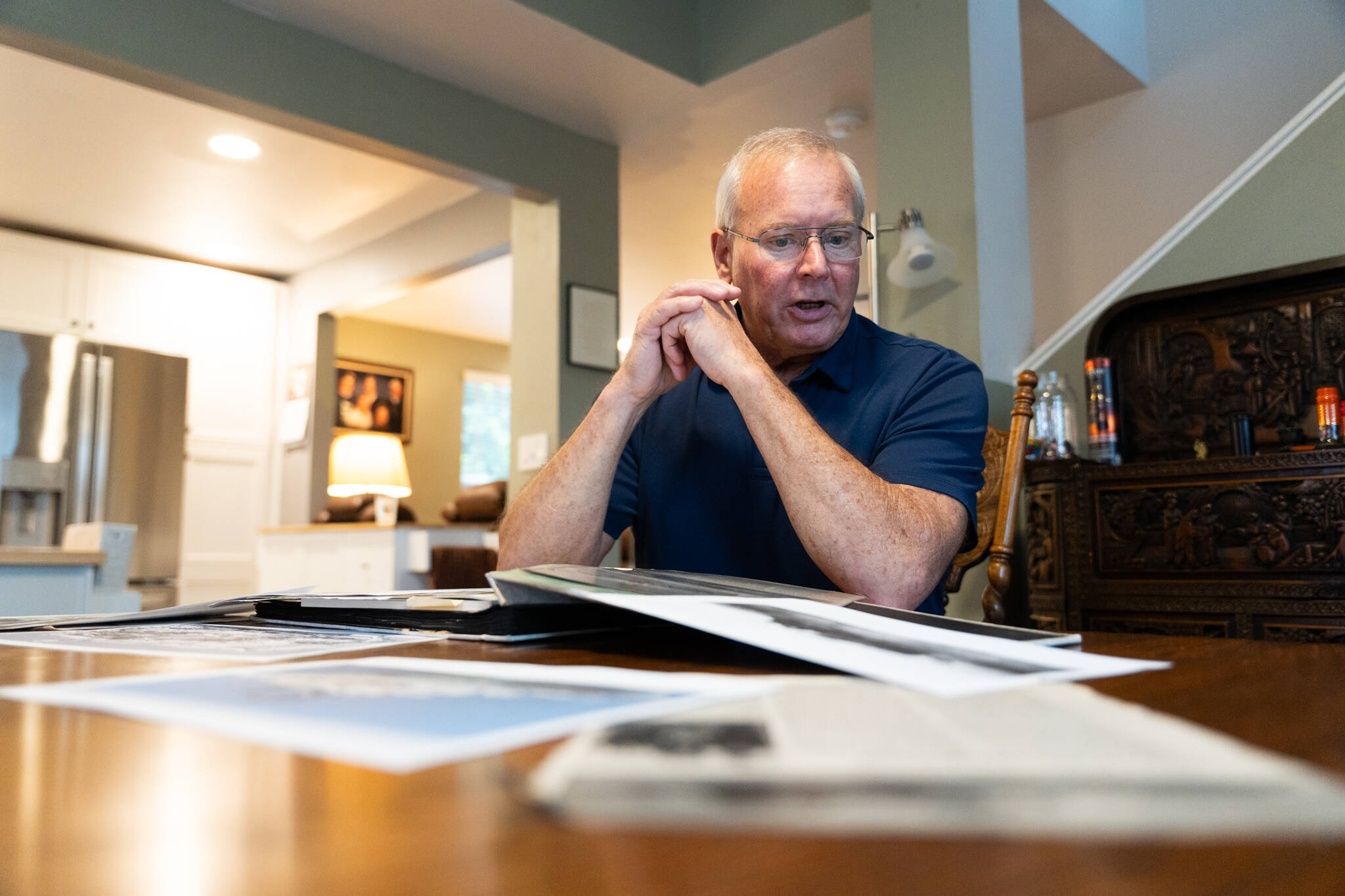 Will Geschke / The Herald
Roger Sharp looks over memorabilia from the USS Belknap in his home in Marysville on Nov. 14.