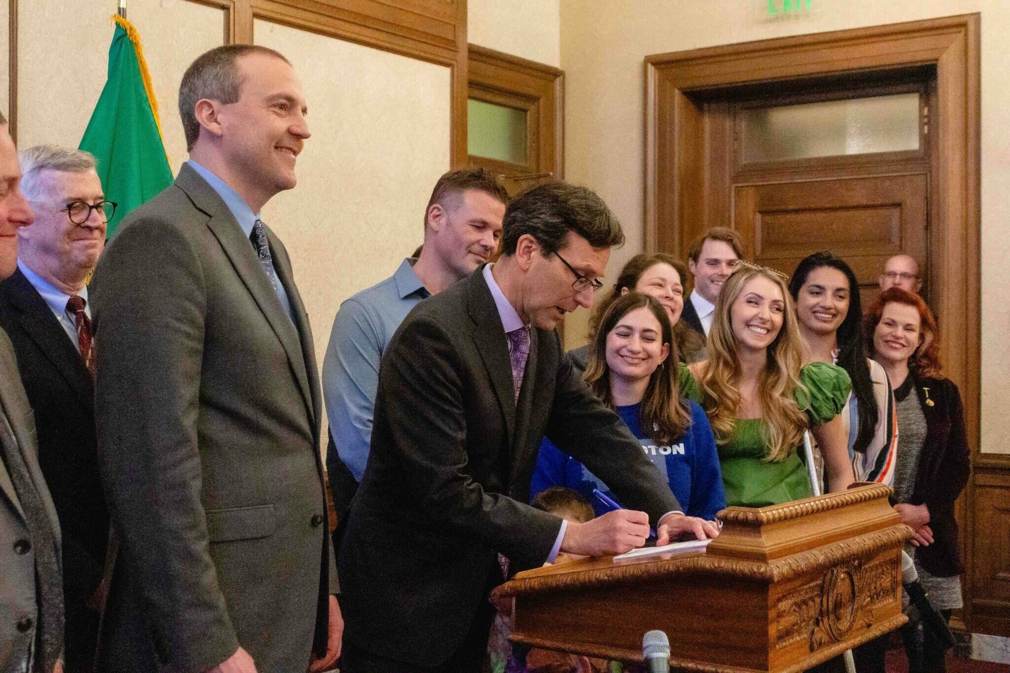 Gov. Bob Ferguson signing Senate Bill 5480, a bill exempting medical debt from credit reports, on April 22, 2025. (Photo by Jacquelyn Jimenez Romero/Washington State Standard)