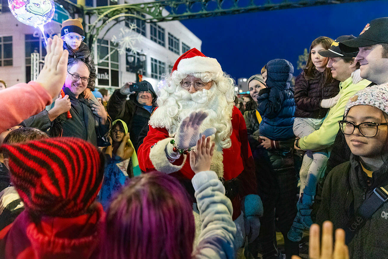 Santa Claus walks through the crowd while giving out high-fives during Wintertide on Nov. 28, 2025 in Everett, Washington. (Olivia Vanni / The Herald)