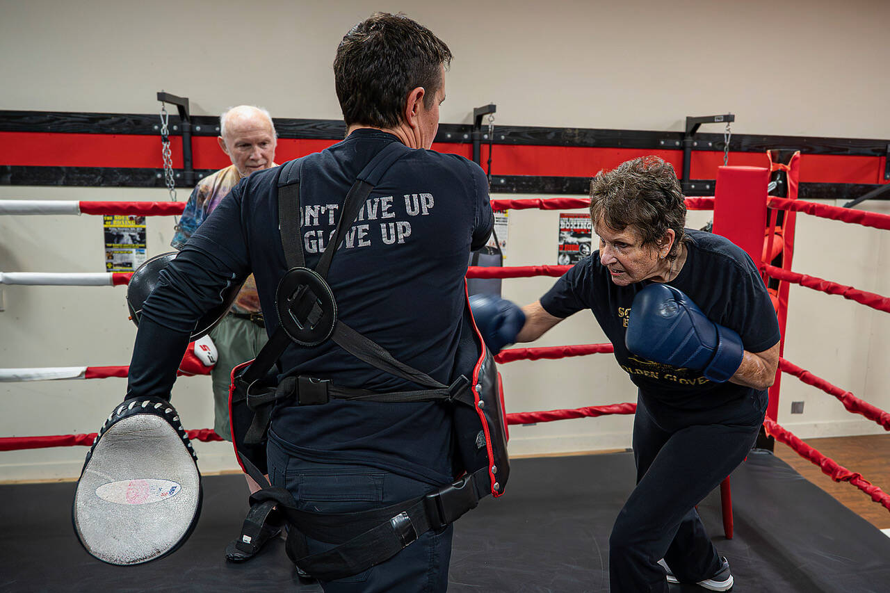 May Sinclaire, Dakota Stone’s mother, practices punching her body shield.