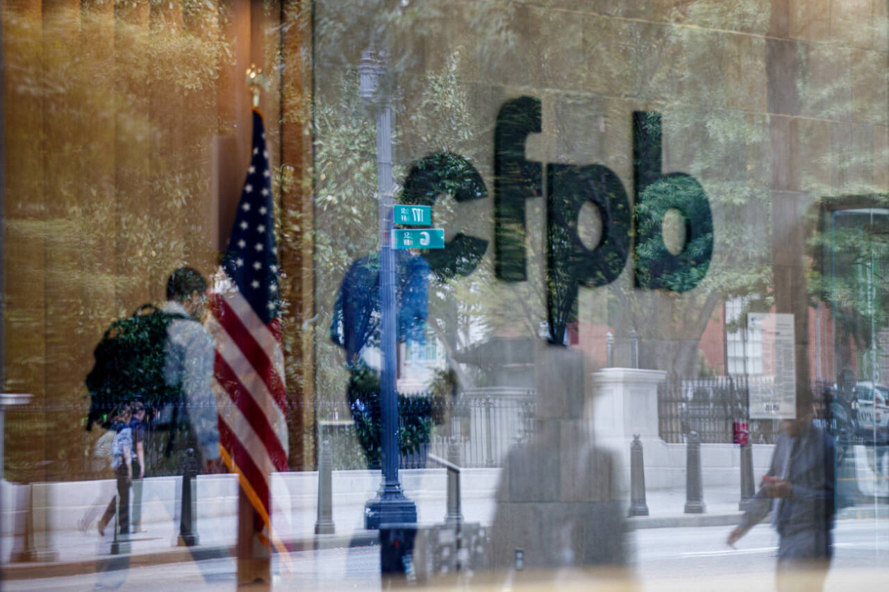 The Consumer Financial Protection Bureau logo is seen through a window at the CFPB offices in Washington, D.C., on Sept. 23, 2019. (Ting Shen / The New York Times)