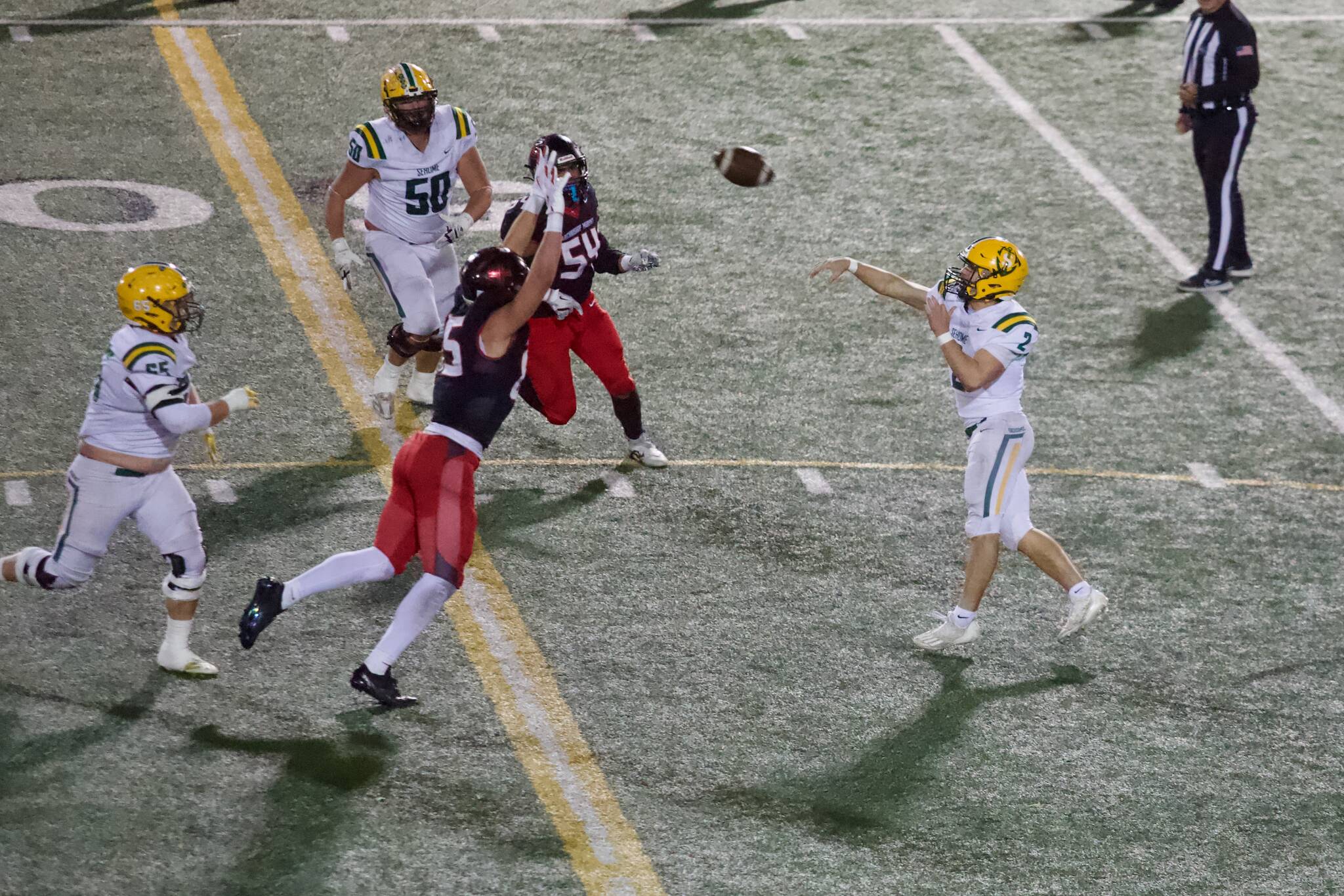Archbishop Murphy senior Jack Sievers stretches his arms up in an attempt to bat down Sehome senior Nolan Wrights pass during the Wildcats 52-20 win against the Mariners in the WIAA 2A State quarterfinals at Goddard Memorial Stadium on Nov. 22, 2025. (Joe Pohoryles / The Herald)