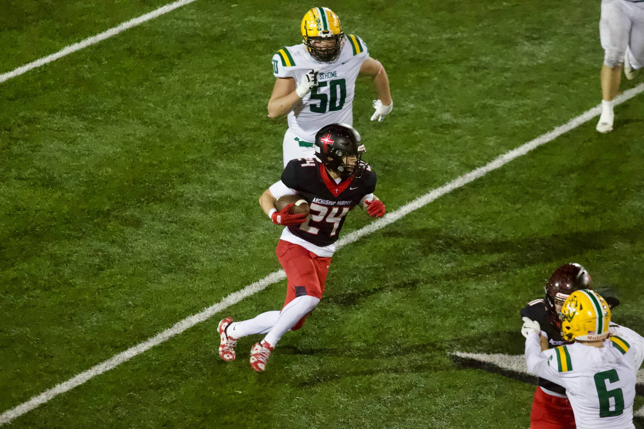 Archbishop Murphy sophomore Ryder Sandstrom takes the ball upfield during the Wildcats' 52-20 win against Sehome in the WIAA 2A State quarterfinals at Goddard Memorial Stadium on Nov. 22, 2025. (Joe Pohoryles / The Herald)