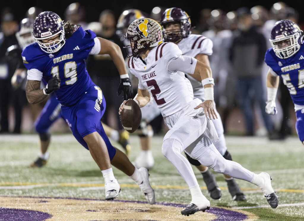 Moses Lakes’s Brady Jay scrambles with the ball during the 4A state football quarterfinal game against Lake Stevens on Nov. 22, 2025 in Lake Stevens, Washington. (Olivia Vanni / The Herald)
