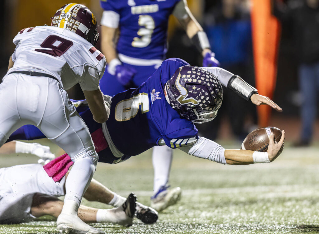 Lake Stevens’ Blake Moser dives towards the end zone with the ball during the 4A state football quarterfinal game against Moses Lake on Nov. 22, 2025 in Lake Stevens, Washington. (Olivia Vanni / The Herald)
