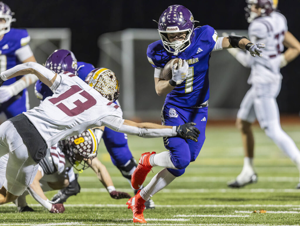Lake Stevens’ Colten Fink escapes a tackle during the 4A state football quarterfinal game against Moses Lake on Nov. 22, 2025 in Lake Stevens, Washington. (Olivia Vanni / The Herald)
