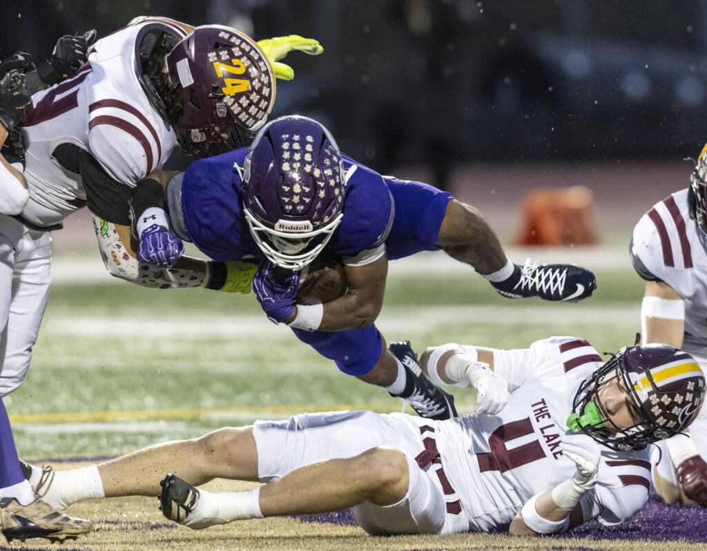 Lake Stevens’ Jayvian Ferrell jumps over a tackle during the 4A state football quarterfinal game against Moses Lake on Nov. 22, 2025 in Lake Stevens, Washington. (Olivia Vanni / The Herald)
