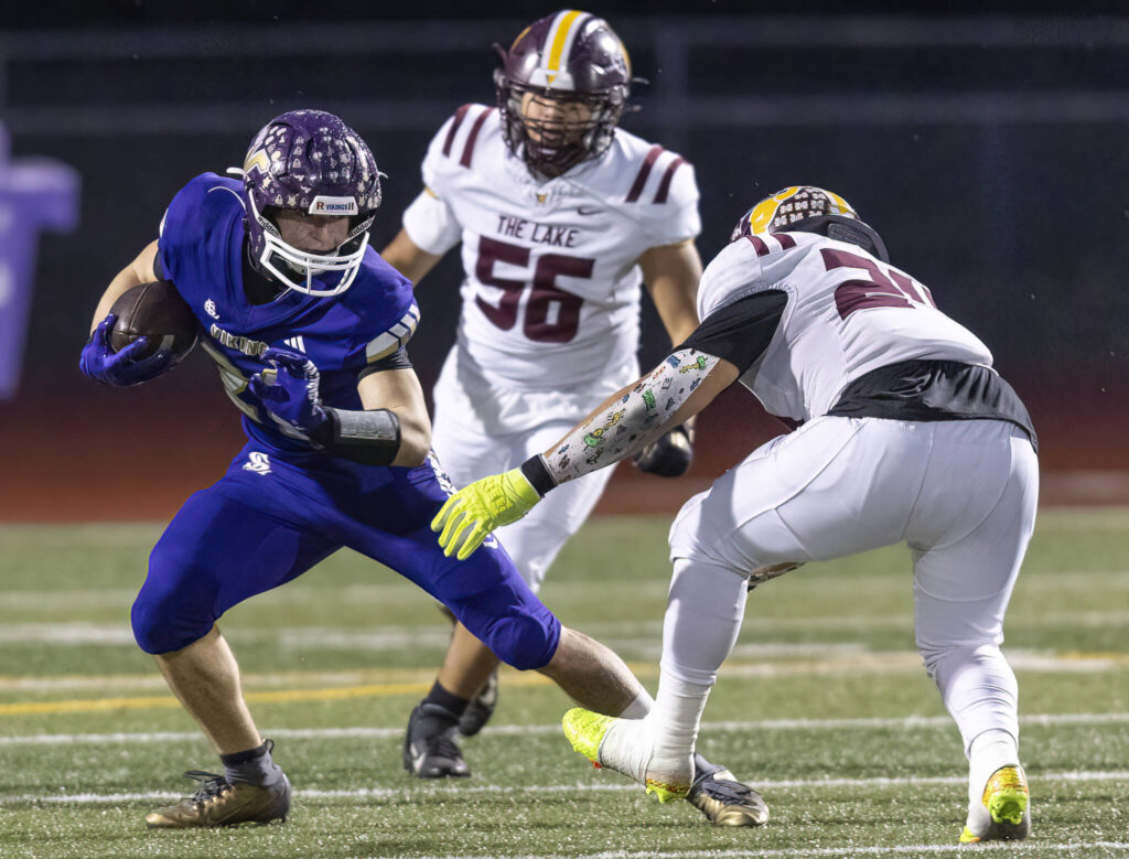 Lake Stevens’ Brian Tilghman escapes a tackle during the 4A state football quarterfinal game against Moses Lake on Nov. 22, 2025 in Lake Stevens, Washington. (Olivia Vanni / The Herald)
