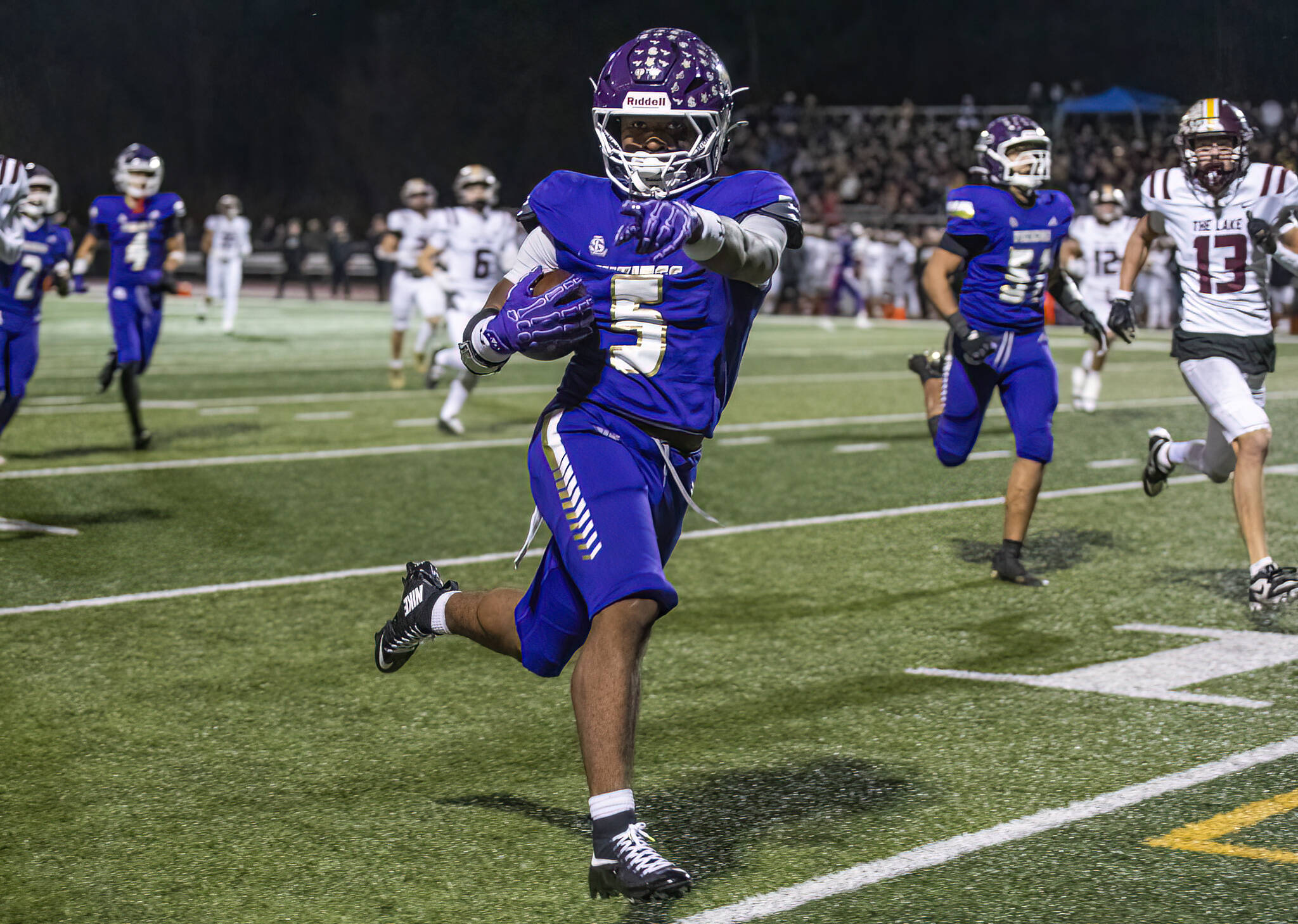 Lake Stevens’ Jayvian Ferrell runs the ball into the end zone for a touchdown during the 4A state football quarterfinal game against Moses Lake on Nov. 22, 2025 in Lake Stevens, Washington. (Olivia Vanni / The Herald)