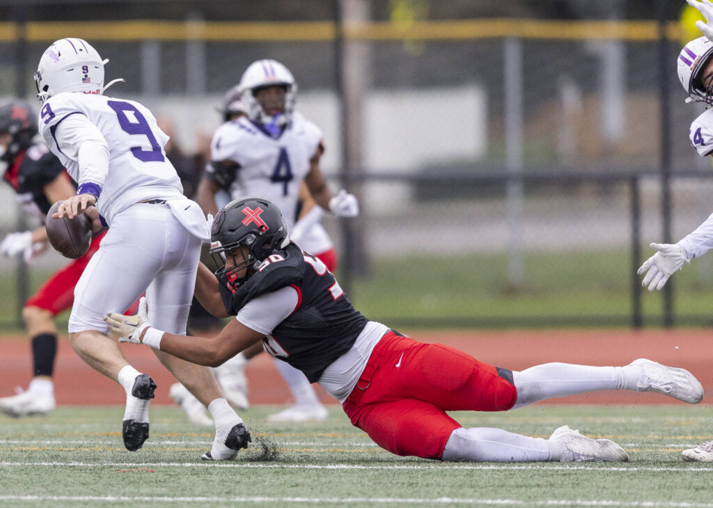 Archbishop Murphy’s William Wilson sacks Anacortes’ Ryan Harrington during the 2A state football semifinal game on Nov. 29, 2025 in Everett, Washington. (Olivia Vanni / The Herald)
