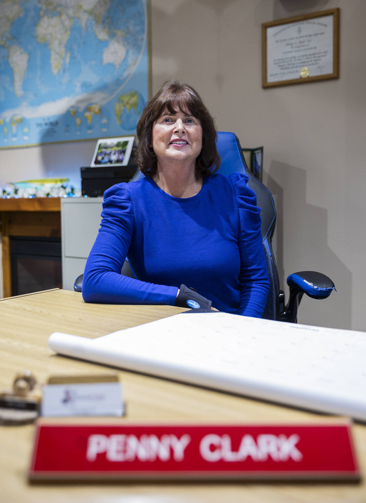 Penny Clark, owner of Travel Time of Everett Inc., at her home office on Nov. 21, 2025 in Arlington, Washington. (Olivia Vanni / The Herald)