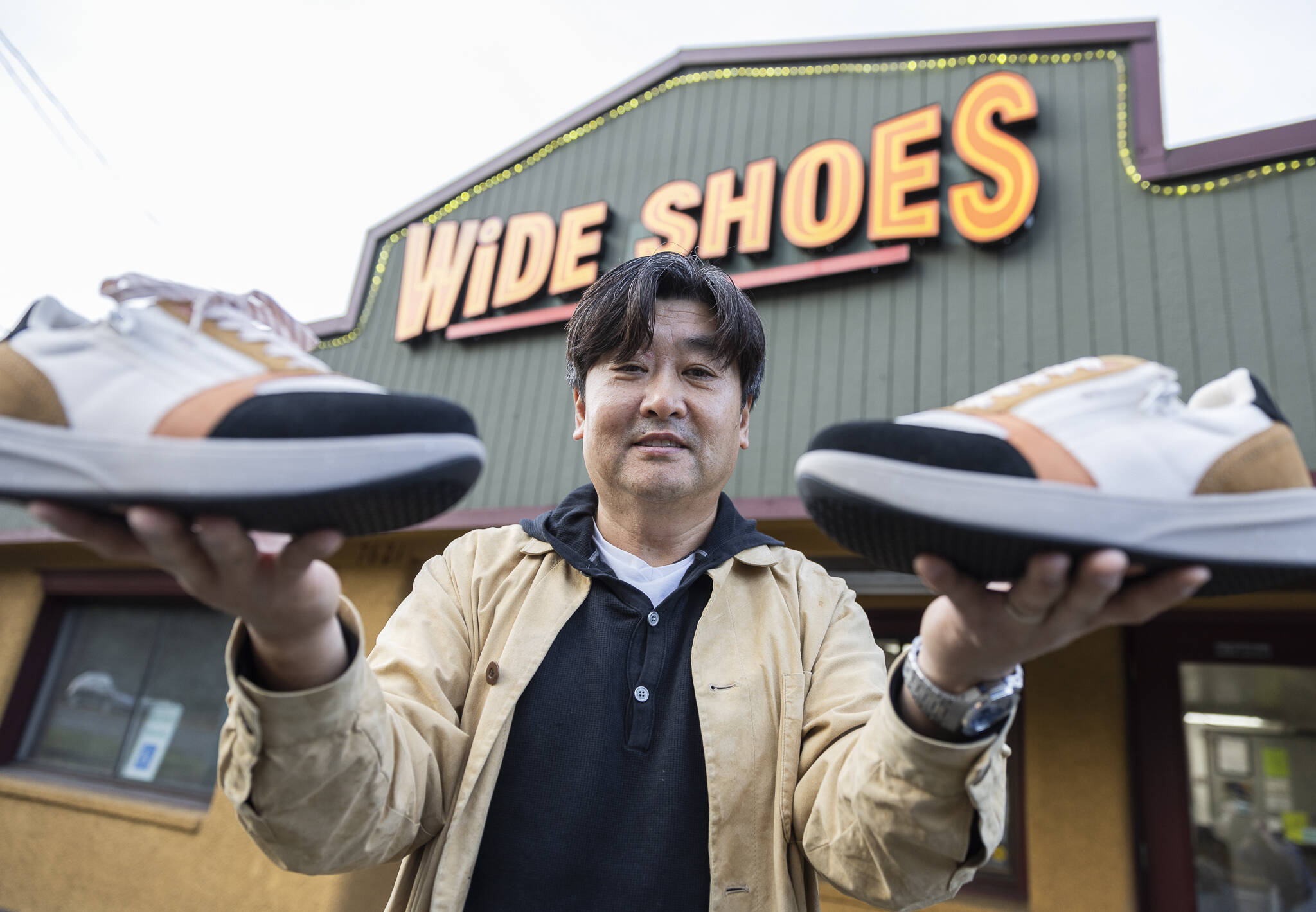 Wide Shoes owner Dominic Ahn outside of his store along 205th Street on Nov. 20, 2025 in Edmonds, Washington. (Olivia Vanni / The Herald)