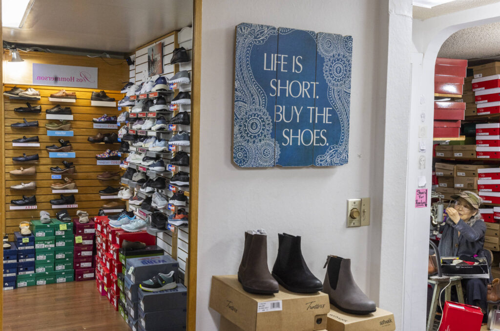 Lina Ahn, the original owner of Wide Shoes, works in the back of the store along 205th Street on Nov. 20, 2025 in Edmonds, Washington. (Olivia Vanni / The Herald)
