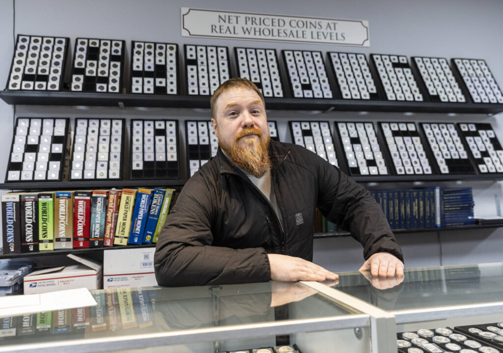 Brendan Geraghty at his store, The Coin Market, on Nov. 25, 2025, in Lynnwood, Washington. (Olivia Vanni / The Herald)
