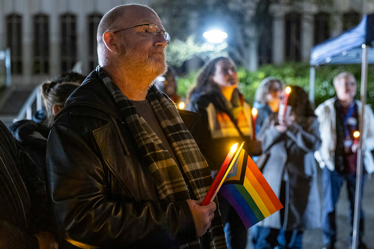 Ian Meyer listens to speakers during a World AIDS Day event at the AIDS Memorial on the Snohomish County Camps on Dec. 1, 2025 in Everett, Washington. (Olivia Vanni / The Herald)