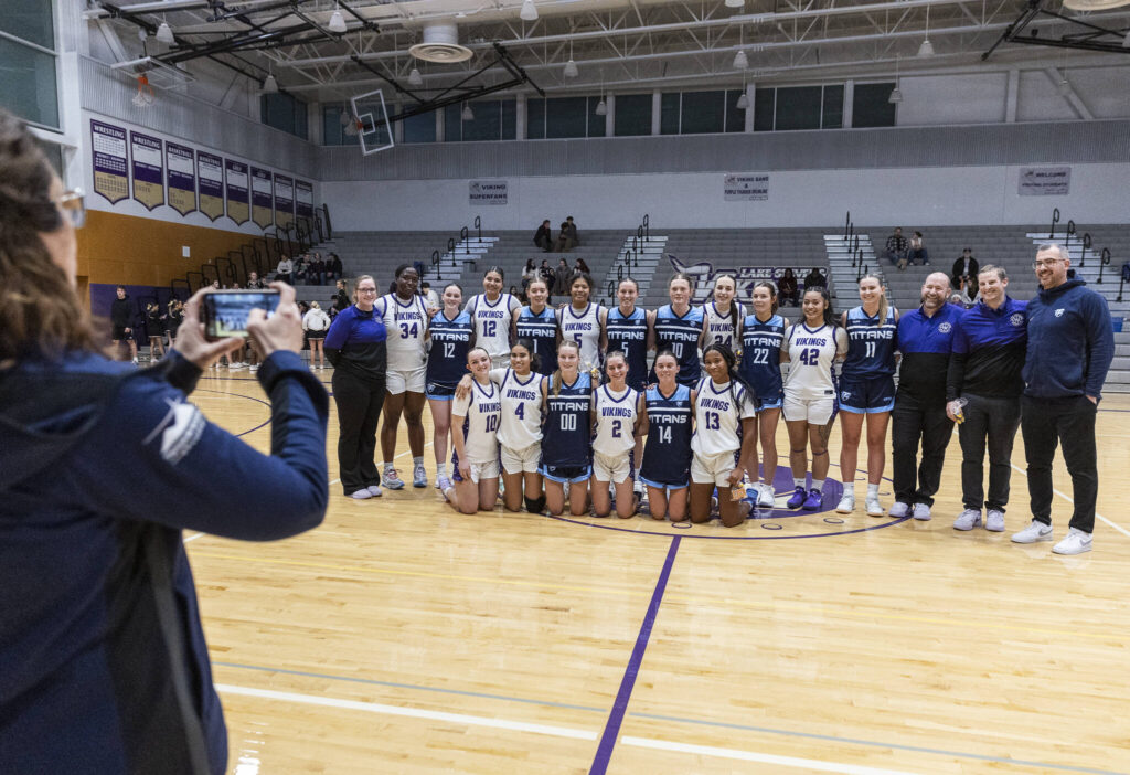 Lake Stevens and Australian team Tenison Woods take a group photo after their game on Dec. 2, 2025 in Lake Stevens, Washington. (Olivia Vanni / The Herald)
