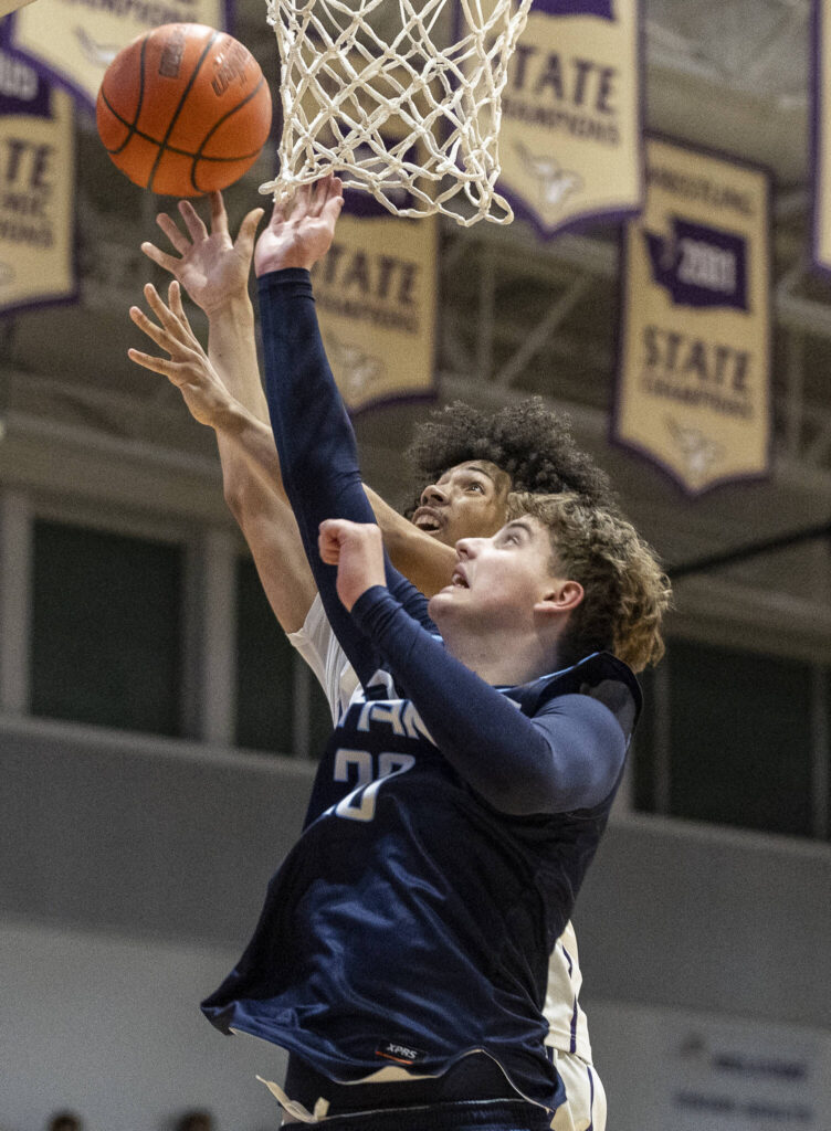 Lake Stevens’ Devin Freeman jumps for a rebound against Tenison Woods during the game on Dec. 2, 2025 in Lake Stevens, Washington. (Olivia Vanni / The Herald)
