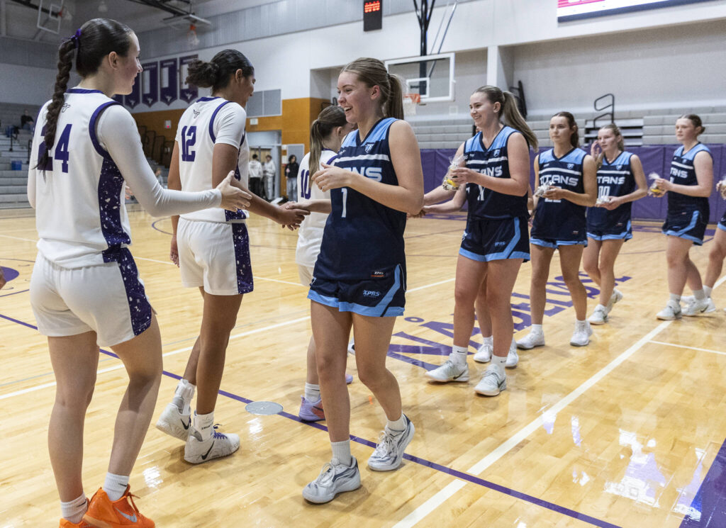 Tenison Woods and Lake Stevens high-five after their game on Dec. 2, 2025 in Lake Stevens, Washington. (Olivia Vanni / The Herald)
