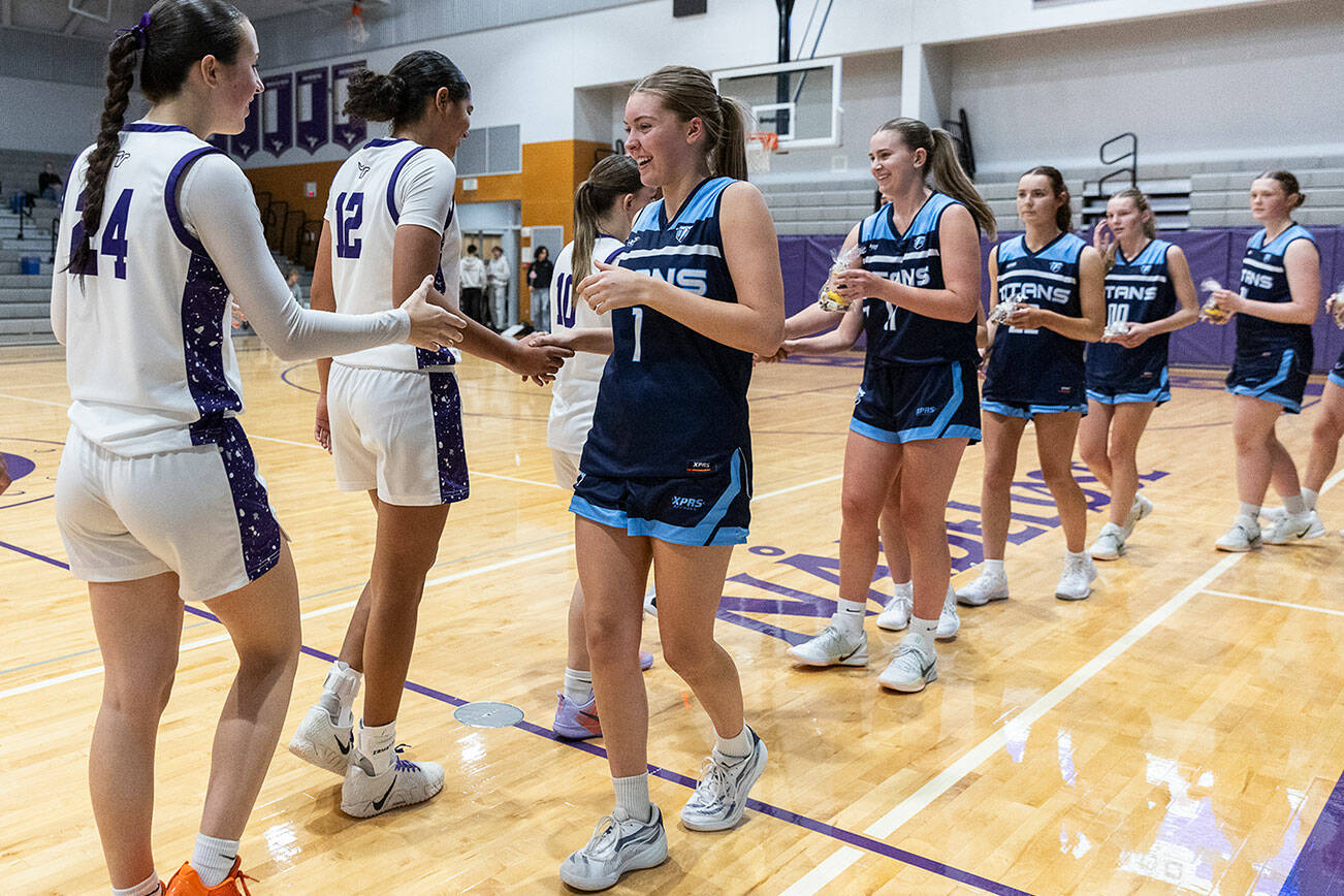 Tenison Woods and Lake Stevens high-five after their game on Dec. 2, 2025 in Lake Stevens, Washington. (Olivia Vanni / The Herald)