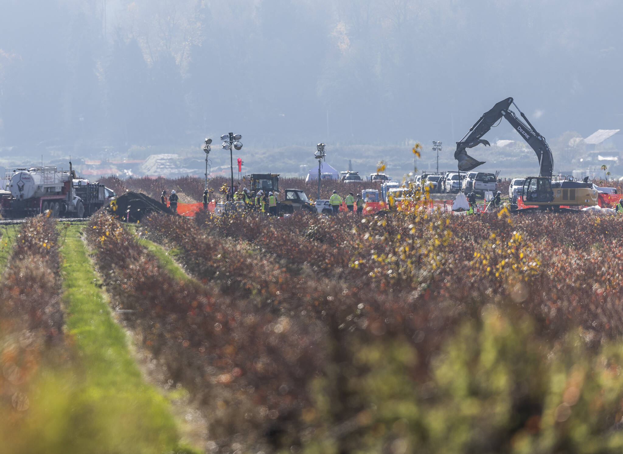 An excavator moves a large bag at the site of a fuel spill on a farm on Nov. 19, 2025 in Everett, Washington. (Olivia Vanni / The Herald)