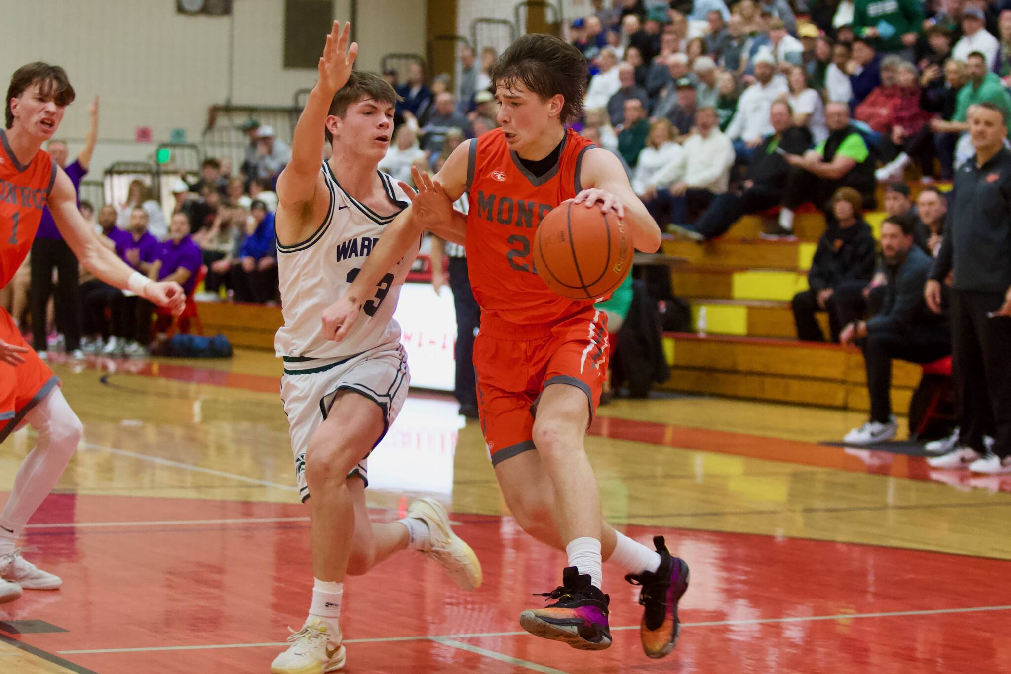 Monroe sophomore Isaiah Kiehl drives the ball down against Edmonds-Woodway junior DJ Karl in the Bearcats’ 61-56 win against the Warriors in the District 1 3A Boys Basketball Championship in Marysville, Washington on Feb. 22, 2025. (Joe Pohoryles / The Herald)