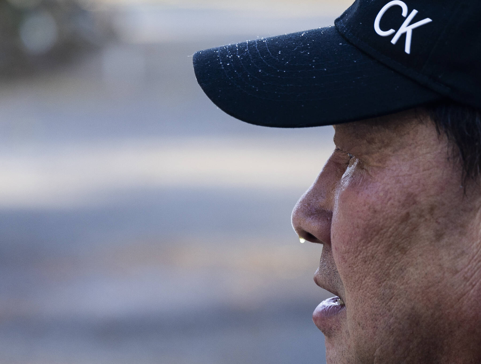 A droplet of water hangs from the tip of Kitburis nose as he gets sprayed with ice and water while sculpting on Sept. 17, 2025 in Marysville, Washington. (Olivia Vanni / The Herald)