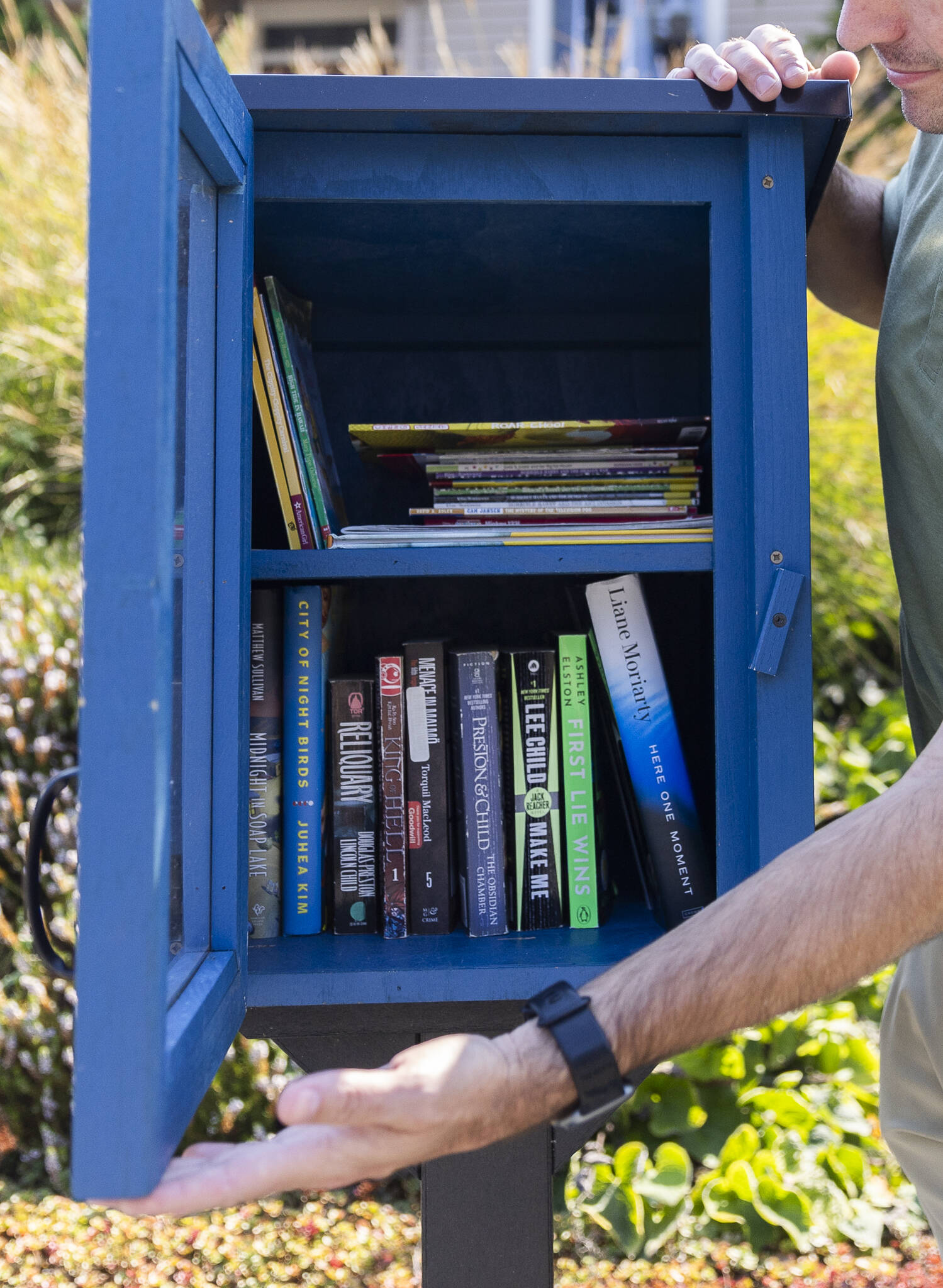 Inside Timothy Walsh’s Little Free Library on Sept. 3, 2025 in Everett. (Olivia Vanni / The Herald)