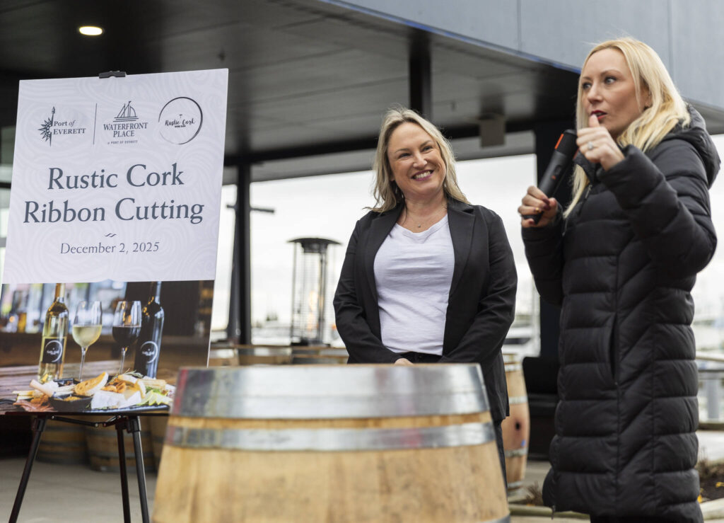 Kelsey Olson, the owner of the Rustic Cork Wine Bar, is introduced by Port of Everett Executive Director Lisa Lefeber on Dec. 2, 2025 in Everett, Washington. (Olivia Vanni / The Herald)
