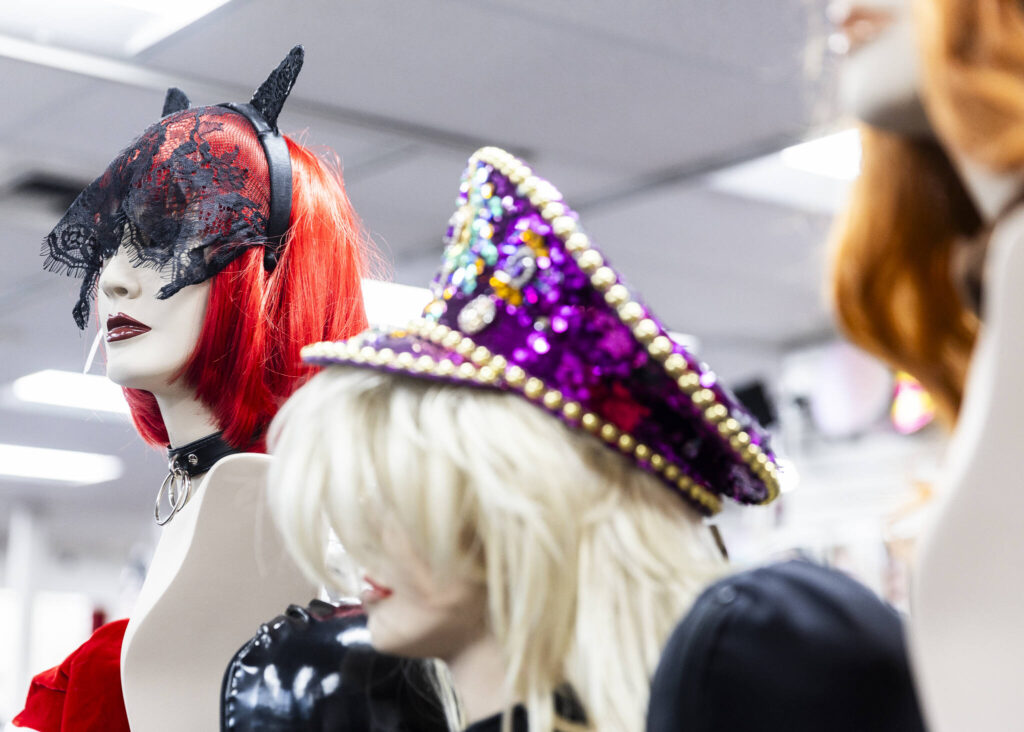 Wigs, chokers, hats and other accessories on display at Lovers Lair on Dec. 19, 2025 in Everett. (Olivia Vanni / The Herald)
