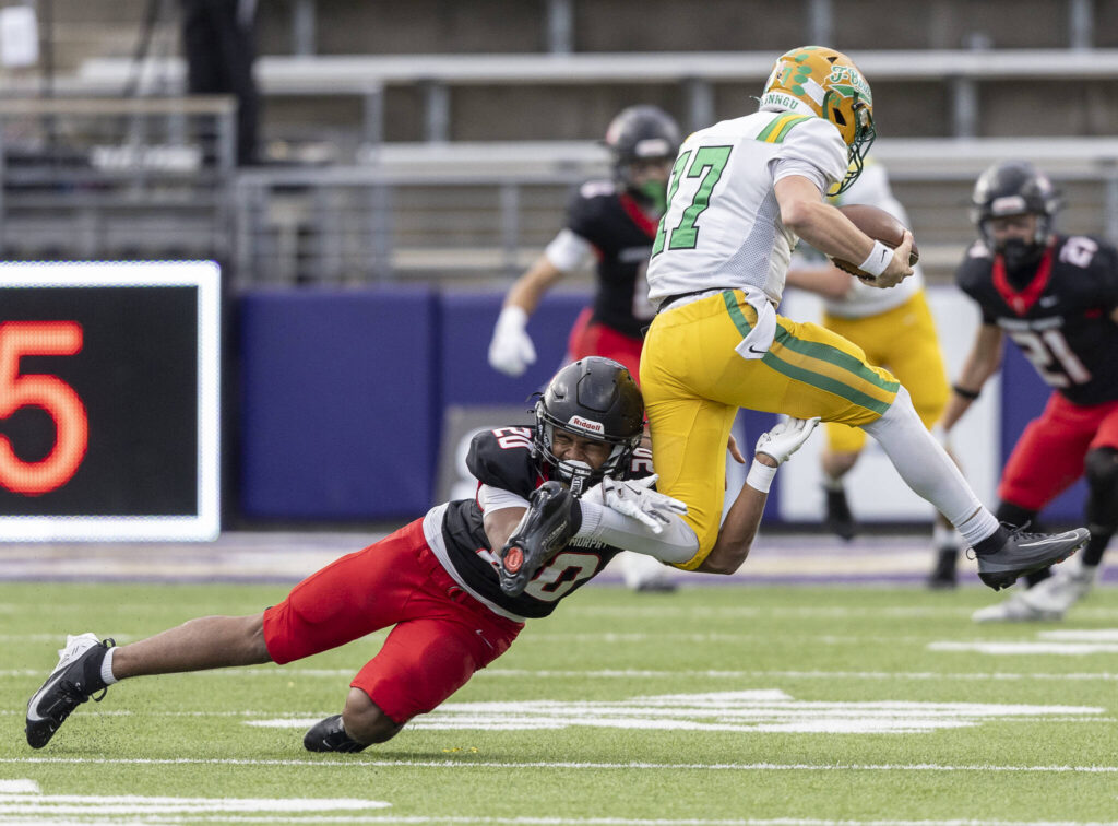 Archbishop Murphy&rsquo;s Isaiah Smith tackles Tumwater&rsquo;s Jaxon Budd during the 2A state championship game at Husky Stadium on Saturday, Dec. 6, 2025 in Seattle, Washington. (Olivia Vanni / The Herald)
