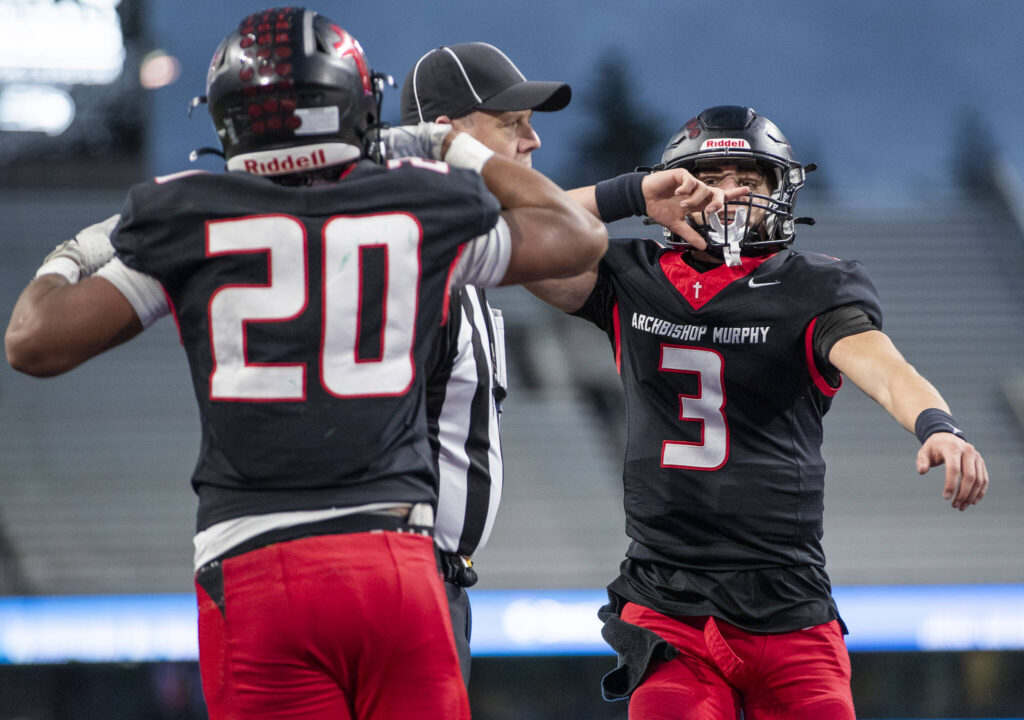 Archbishop Murphy&rsquo;s Evan Ruiz celebrates teammate Isaiah Smith&rsquo;s touchdown during the 2A state championship game against Tumwater at Husky Stadium on Saturday, Dec. 6, 2025 in Seattle, Washington. (Olivia Vanni / The Herald)
