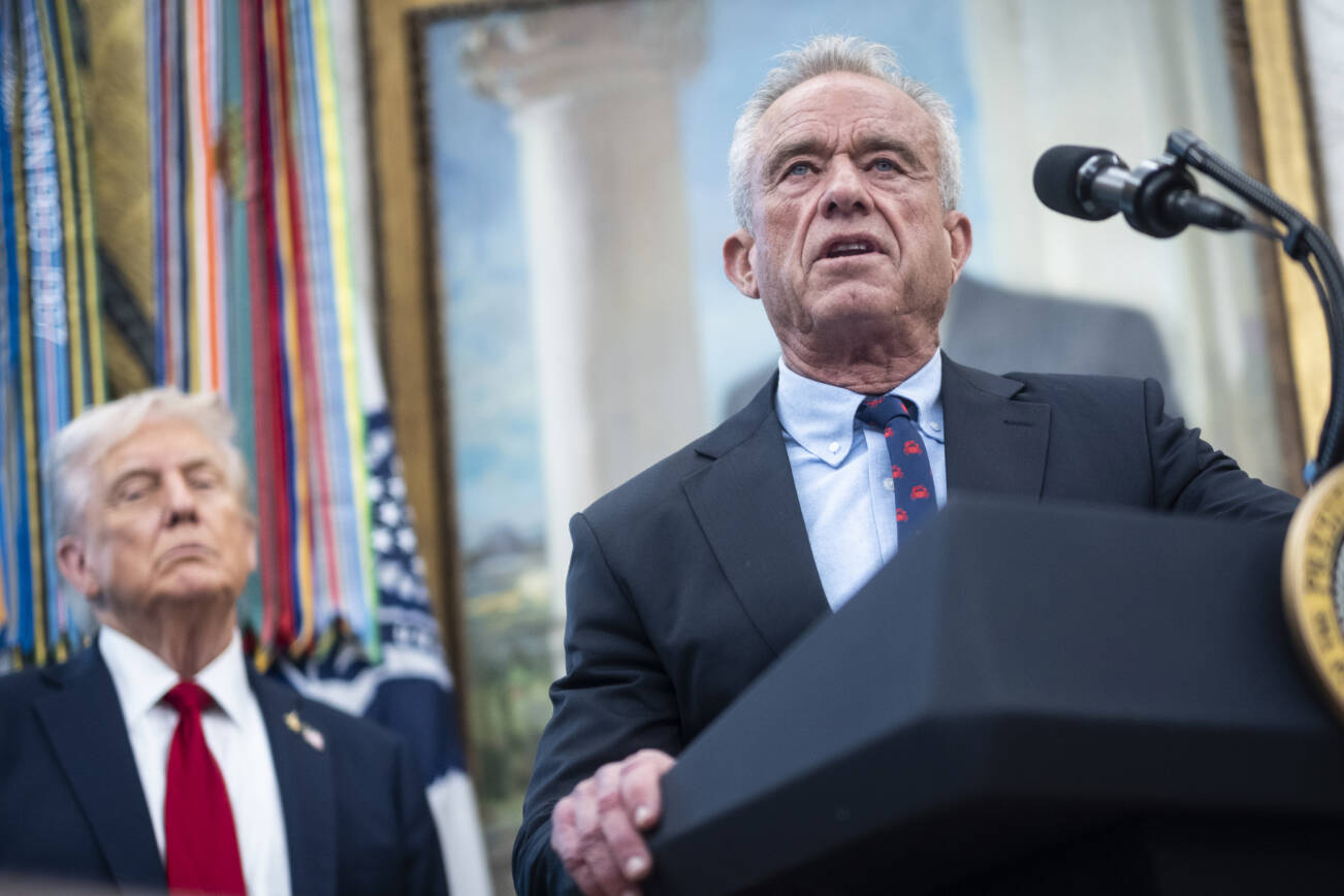 FILE — Health and Human Services Secretary Robert F. Kennedy Jr. speaks alongside President Donald Trump during an event announcing a drug pricing deal with Pfizer in the Oval Office of the White House in Washington, Sept. 30, 2025. Advisers to Kennedy appear poised to make consequential changes to the childhood vaccination schedule, delaying a shot that is routinely administered to newborns and discussing big changes to when or how other childhood immunizations are given. (Pete Marovich/The New York Times)