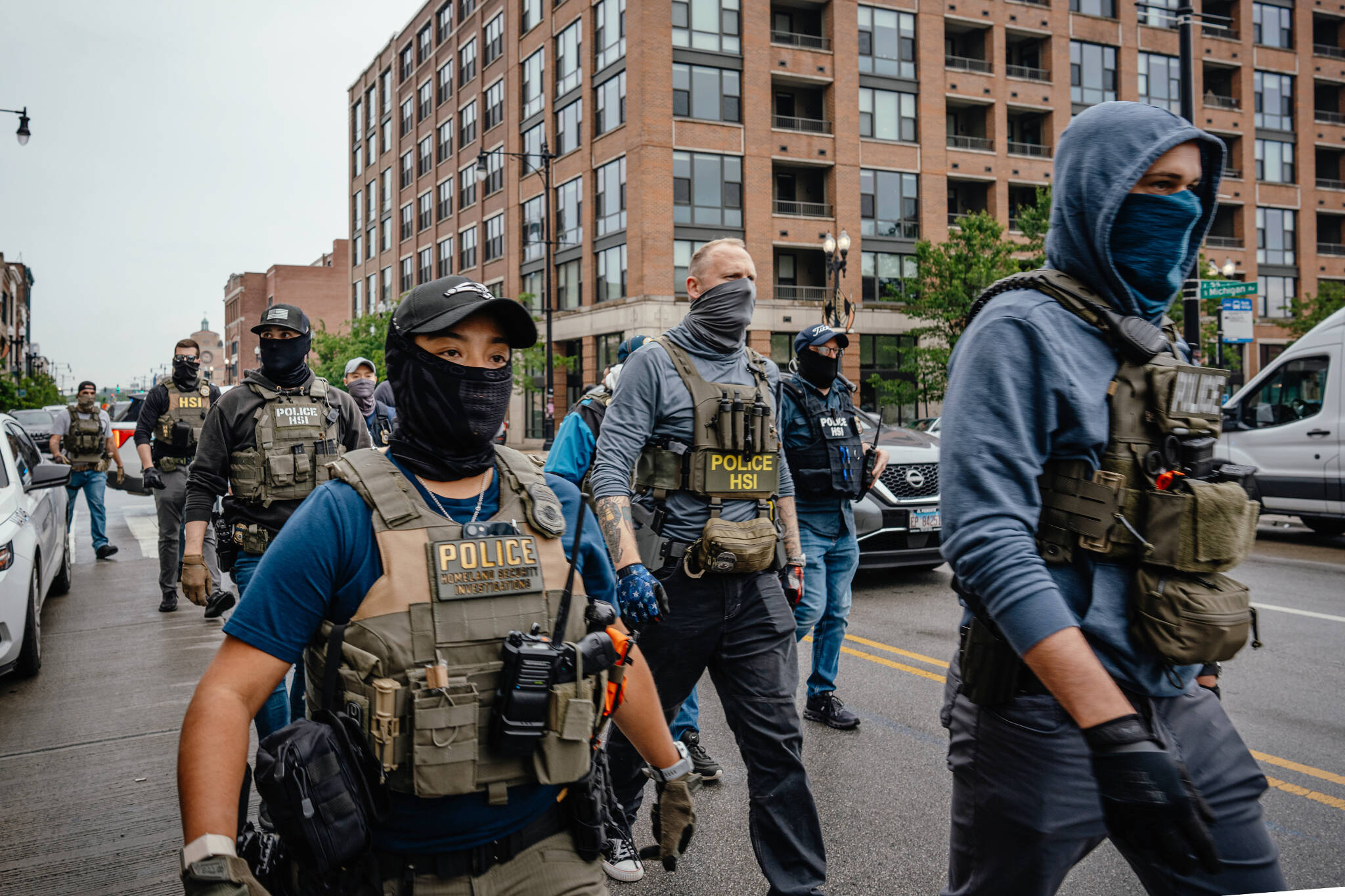 Masked federal agents arrive to help immigration agents detain immigrants and control protesters June 4 in Chicago. California in September became the first state to ban law enforcement officers from wearing face coverings, in response to immigration raids where federal agents wore masks. (Jamie Kelter Davis/The New York Times)
