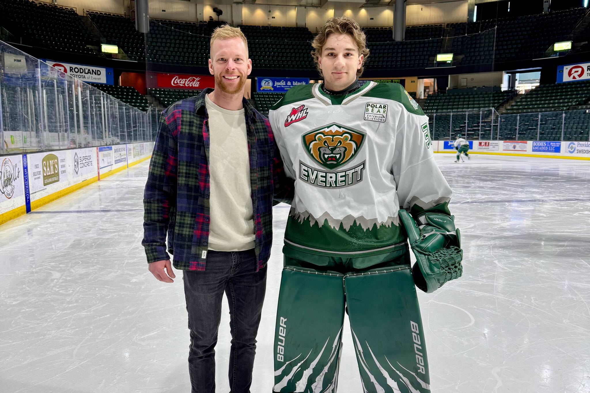 Silvertips goalie Raiden LeGall (right) stands with his hometown goalie coach Tim Morison on the ice at Angel of the Winds Arena. (Photo courtesy of Tim Morison)