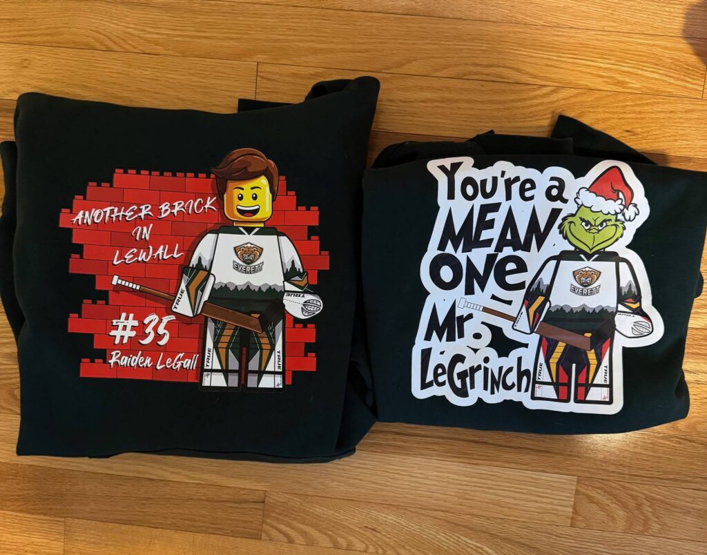 The &lsquo;Another Brick in LeWall&rsquo; and &lsquo;LeGrinch&rsquo; merchandise, designed by Justin Morison, laid out side by side. (Photo courtesy Tim Morison)
