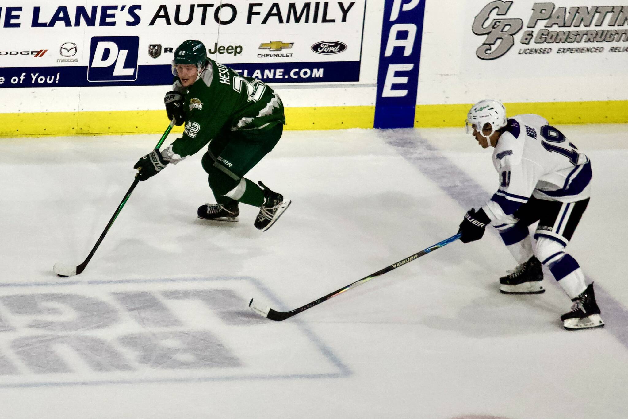 Silvertips forward Jesse Heslop (left) pushes through the neutral zone during Everetts 9-4 win against Victoria at Angel of the Winds Arena on Oct. 4, 2025. (Joe Pohoryles / The Herald)