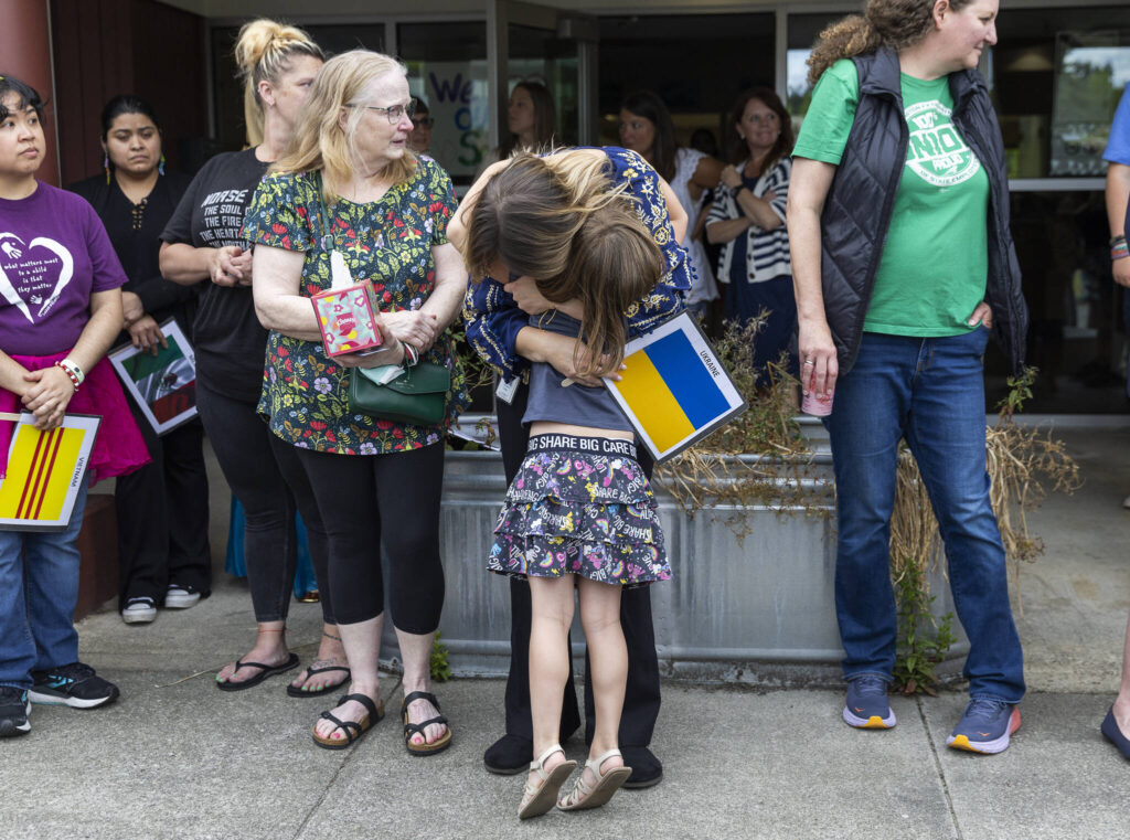 Student Azhura Brown, 5, hugs teacher Anzhelika Huliar on Wednesday, June 25, 2025, in Everett, Washington. (Olivia Vanni / The Herald)
