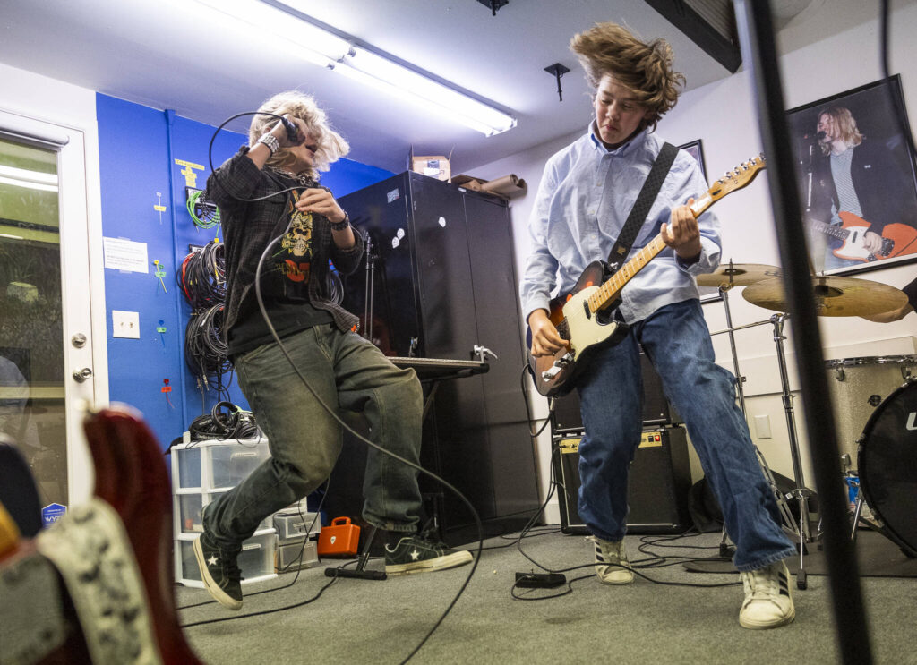 JJ Sobchuk, 14, left, and Owen Barton, 14, jump while doing a run through during a group lesson at the Music Circle on Dec. 1, 2025, in Everett, Washington. (Olivia Vanni / The Herald)
